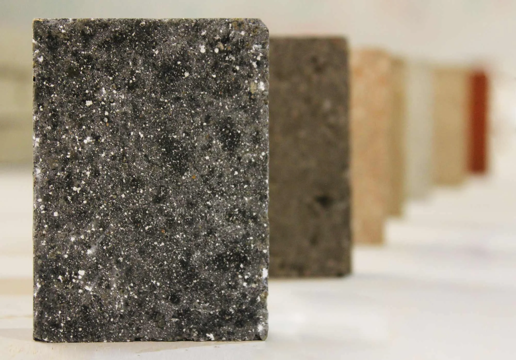 Supplementing cement with rice husk ash contributes to a unique and pleasing appearance; the dark tones induced by basaltic aggregates and rice husk ash contrast nicely with white coloration from crushed recycled concrete and mineral aggregates.