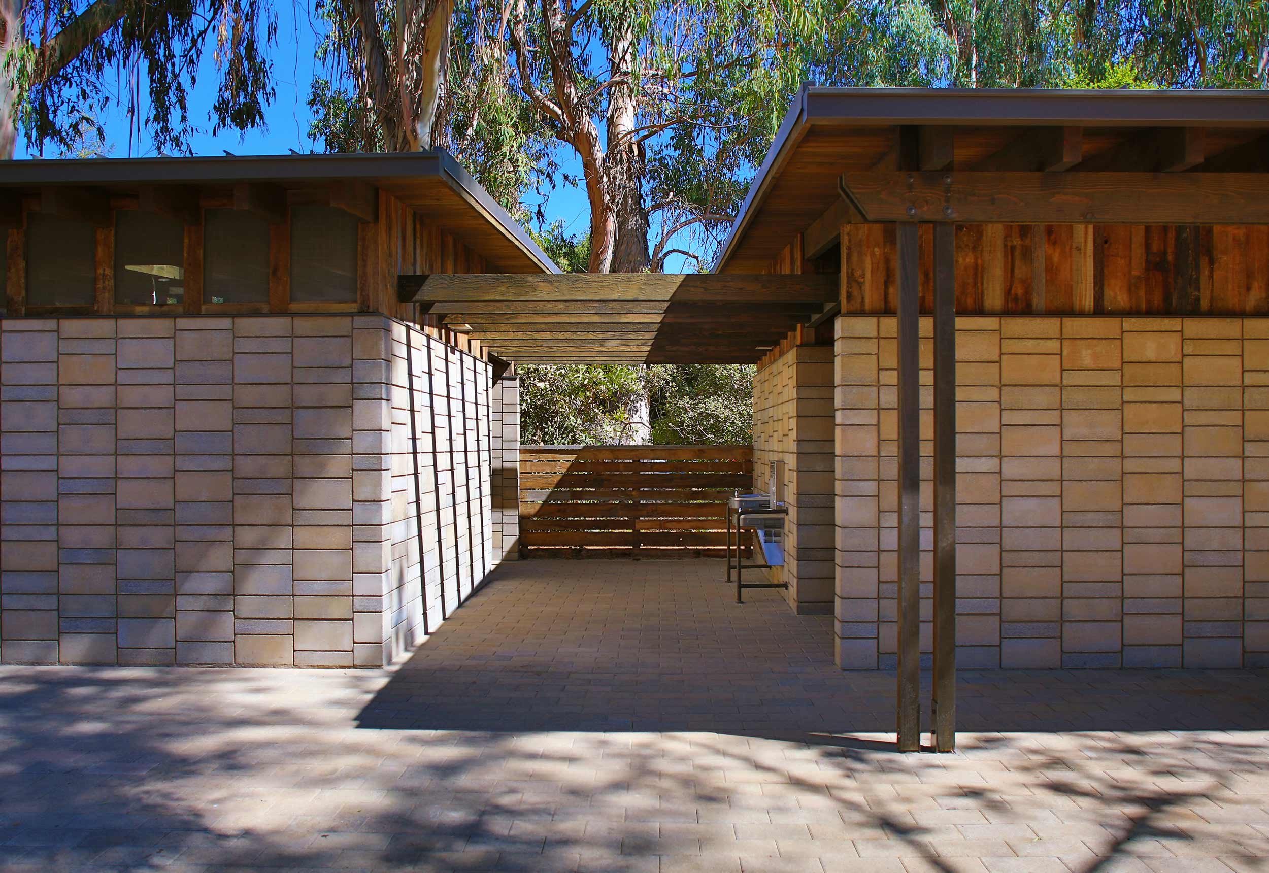 Deep in a eucalyptus grove on the Stanford University campus, architect Chris Dorman combined two thousand C-90 compliant Stanford Watershed Block with reclaimed timber and barnwood siding to demonstrate the beauty and utility of wise resource reuse. The Stanford Watershed Block's palette earns its rich reddish brown hue from faint amounts of red clay mixed with Mark West Springs basalt and Nun’s Canyon quarry fines, inspired by the rich reddish-brown sandstone beneath the Stanford campus. The red clay content was purposefully varied during the manufacturing run to accentuate the block’s coloration range. Image © SkyHawk Photography - Brian Haux .