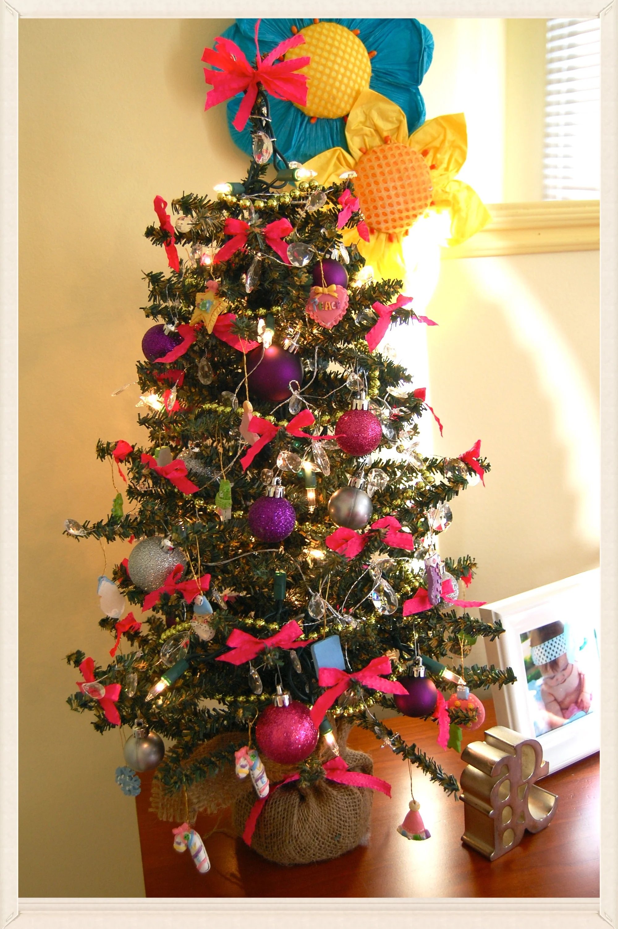 Lucy's princess tree ♥ small Christmas tree . hot pink satin ribbon . jewel garland . green, beaded garland . sparkly balls . miniature ornaments *I'm not sure who is enjoying this one more