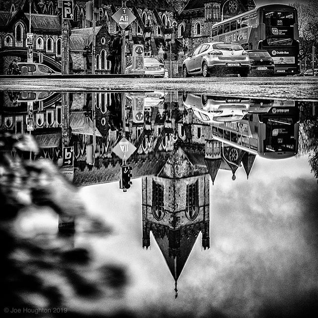 Christchurch reflection... The constraint of a square format allows for choices in focus of viewpoint. When my wife saw this she remarked that she had never been so aware of the arches and windows of the cathedral until she saw it without the tower.