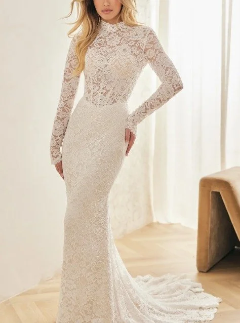New Arrival!
I'm thrilled to share details about this showstopping gown!
This long-sleeve Raschel lace gown features a scalloped high neckline over a sheer bodice with exposed boning for a beautifully structured look. The sleeves are exquisitely det