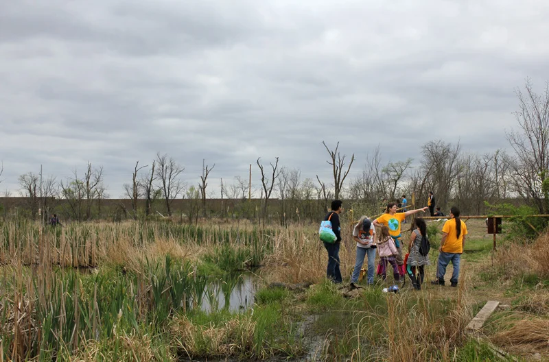 Volunteers receive instructions at Haskell’s 1 st Annual Wetland Restoration Day .