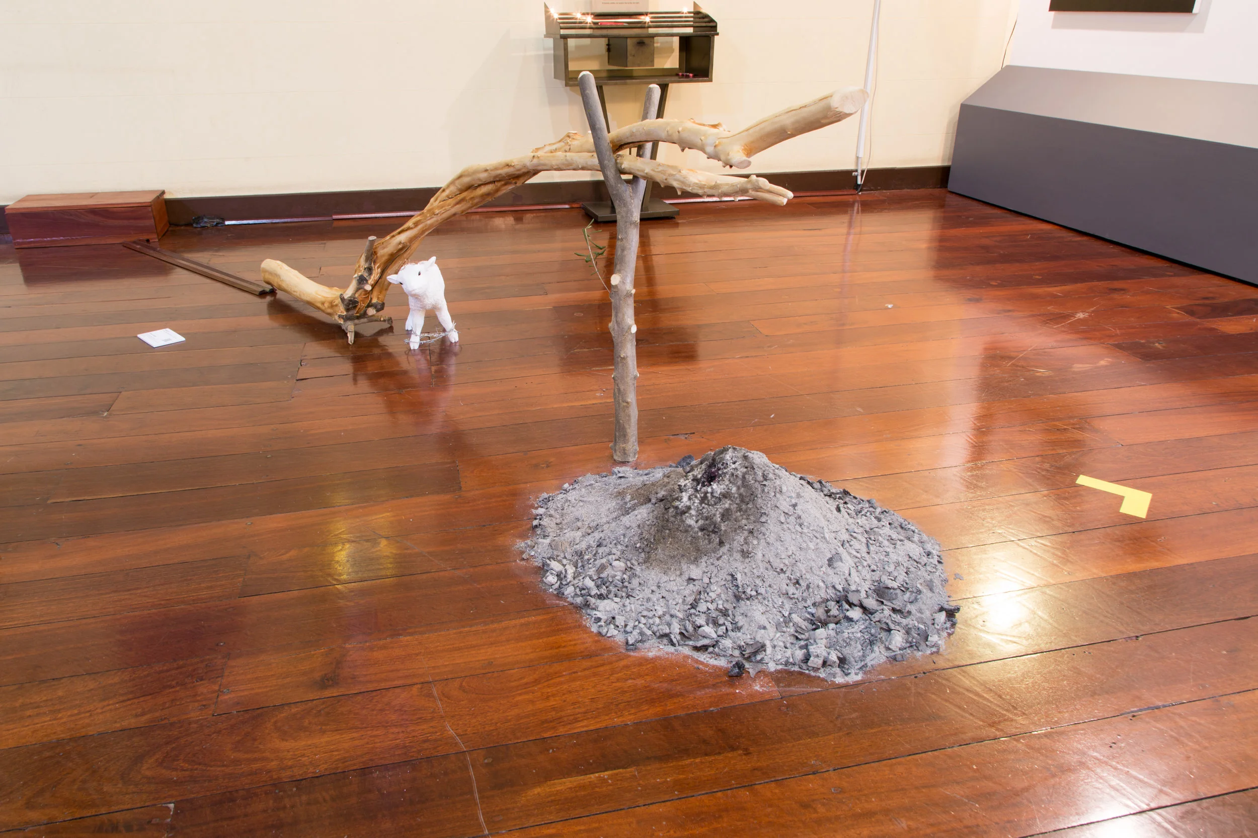 Station 5: Simon of Cyrene Helps Jesus Carry His Cross Donna Franklin Via Dolorosa (Way of Grief) 2016, Ash, clay, copper, graphite, earth, olive wood, silver and wine. 100 x 278cm