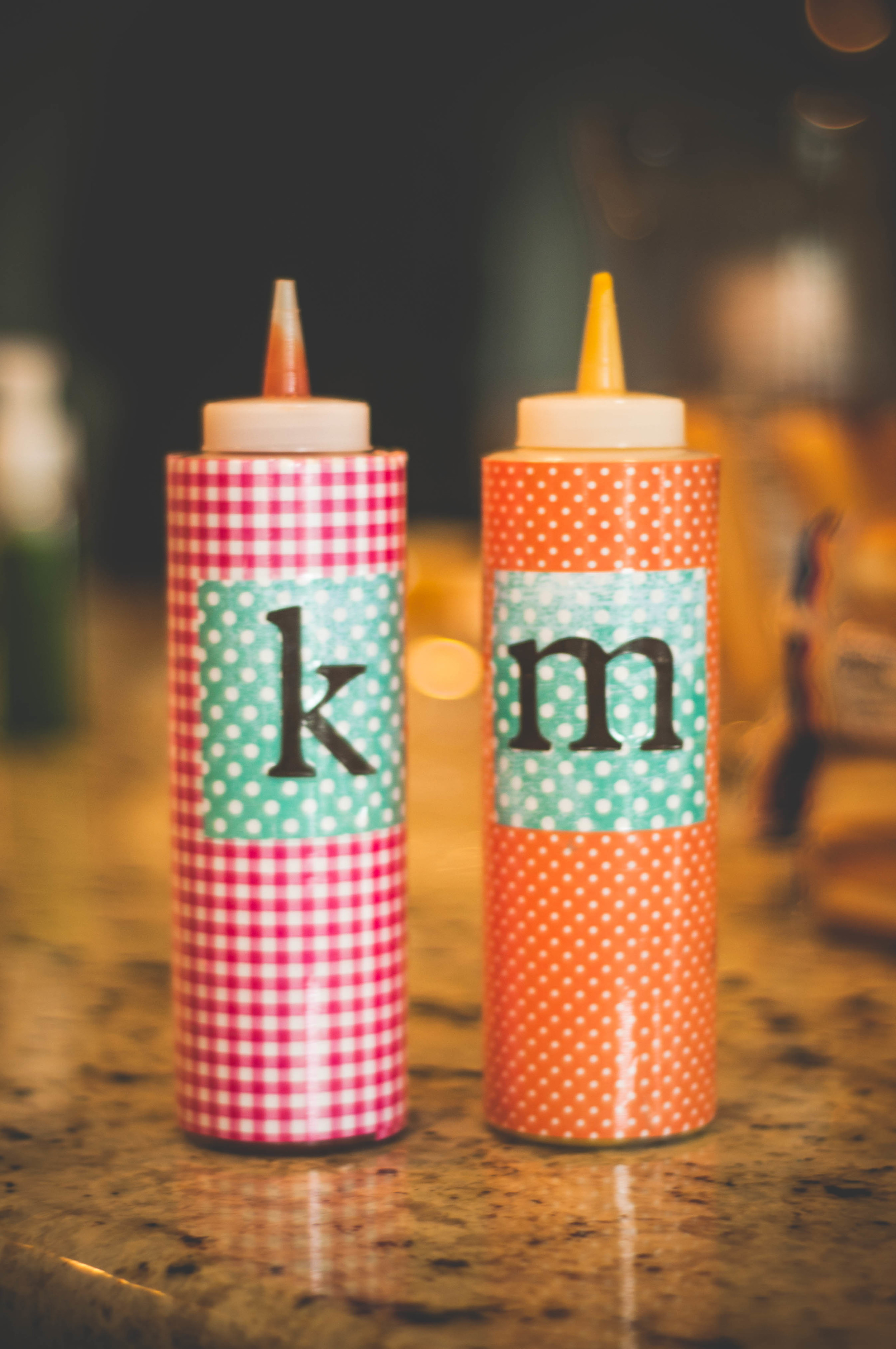 You can buy these condiment bottles for $1 or $2-- I covered in paper that matched our party and added initials also cut out on the cricut and then wrapped the whole thing in clear packing tape. 