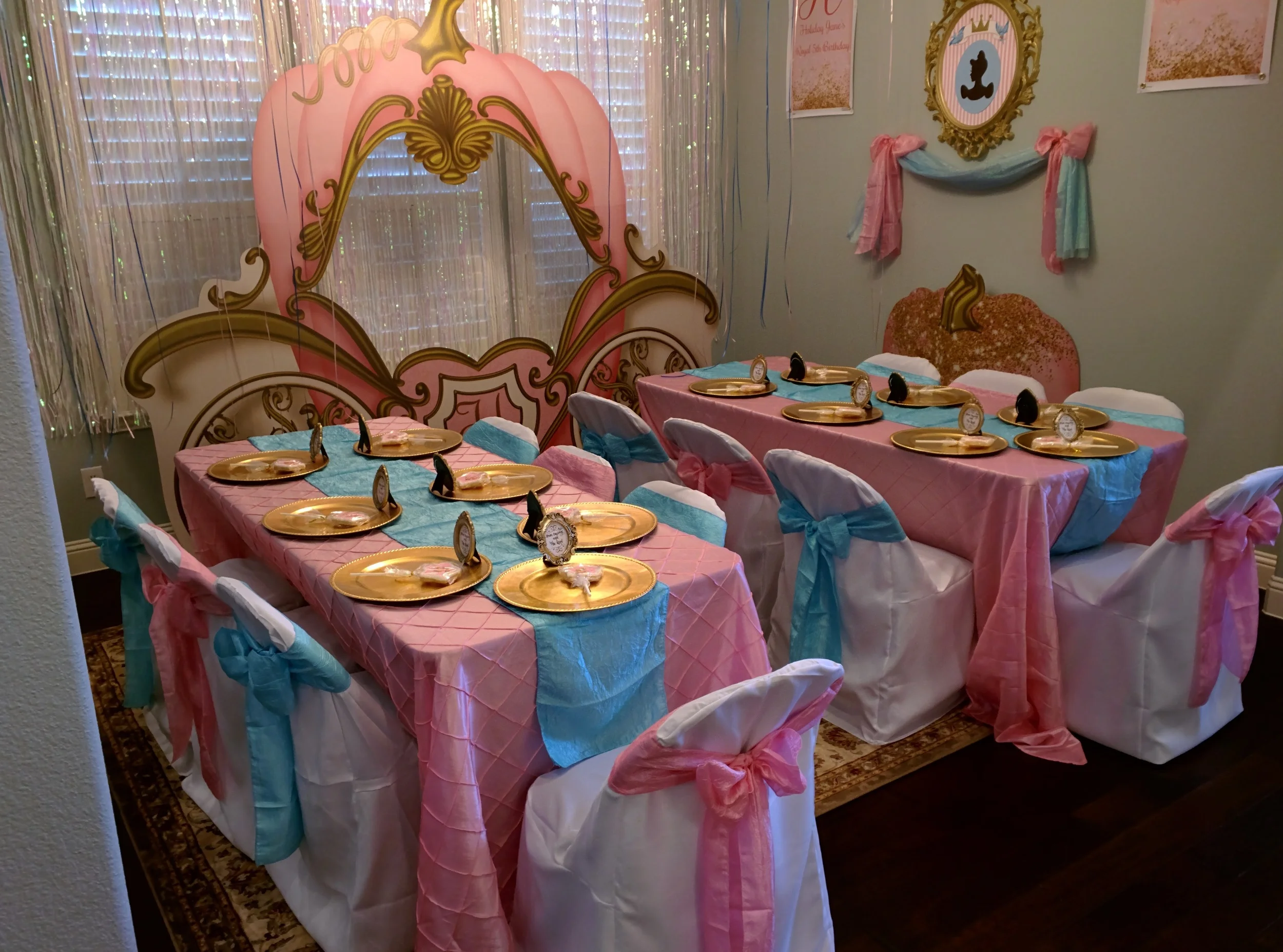 Our Royal Ballroom. I pulled out our Dining Room furniture and replaced it with two 6 foot folding tables and folding chairs all draped in beautiful linens! The gold chargers were one of my favorite things I added. They're easy to find for around $2ea and I think they really made a huge impact! 
