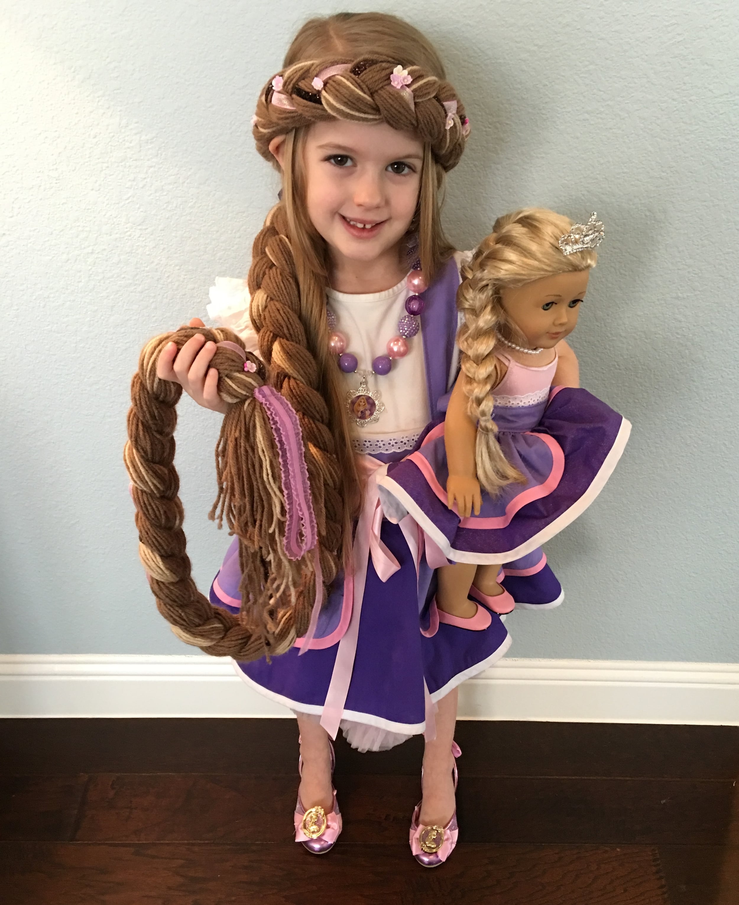 Amazing hair (it's made out of yarn and has a stretch for a perfect, comfortable fit), Rapunzel apron and matching doll apron by Ross and Rosie Designs ! 