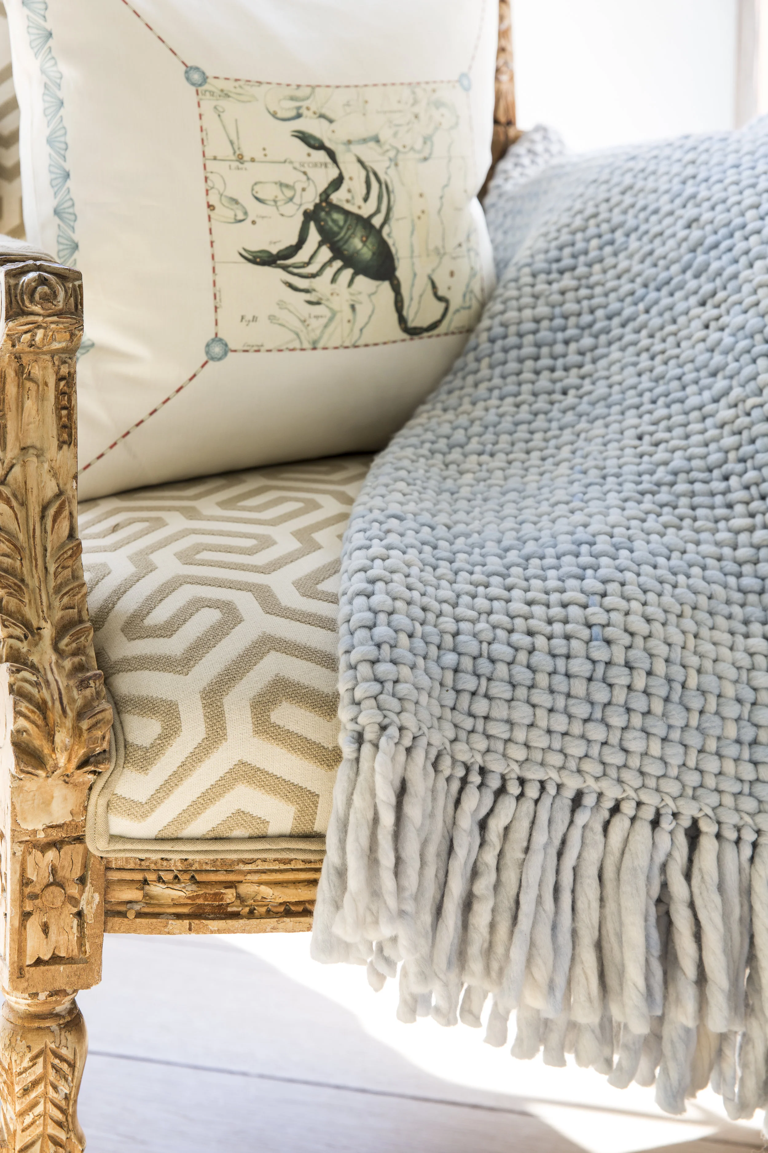 Contemporary chair with pillow and throw
