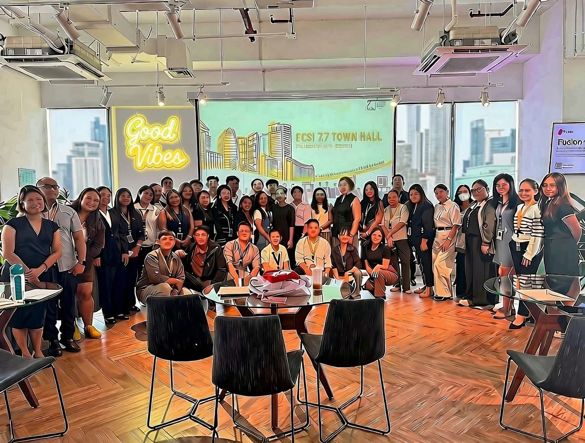 The ExcellerCSI team at the 7.7 Town Hall in their new office, with windows overlooking the city
