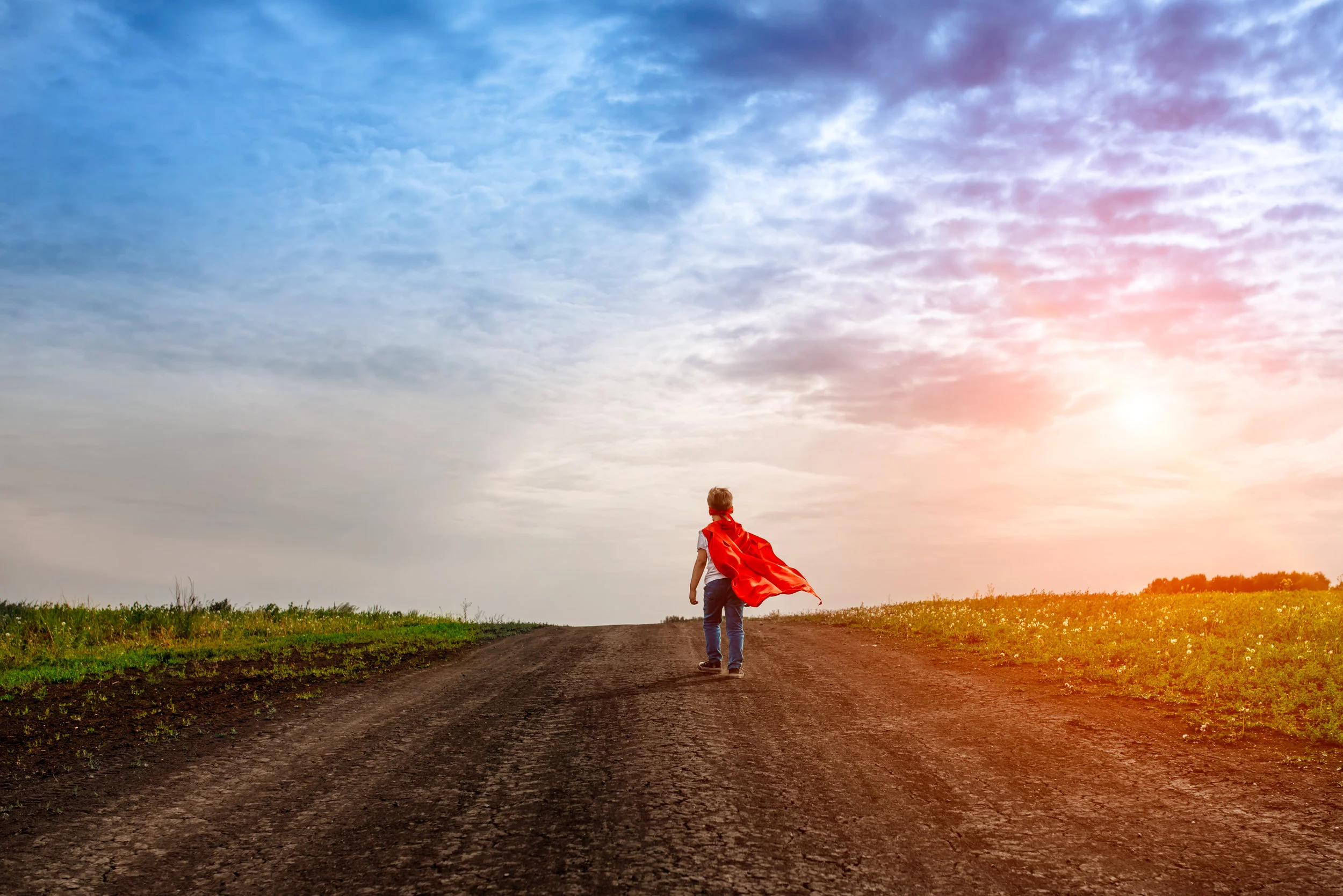 the little preschool boy, plays the superhero outdoors