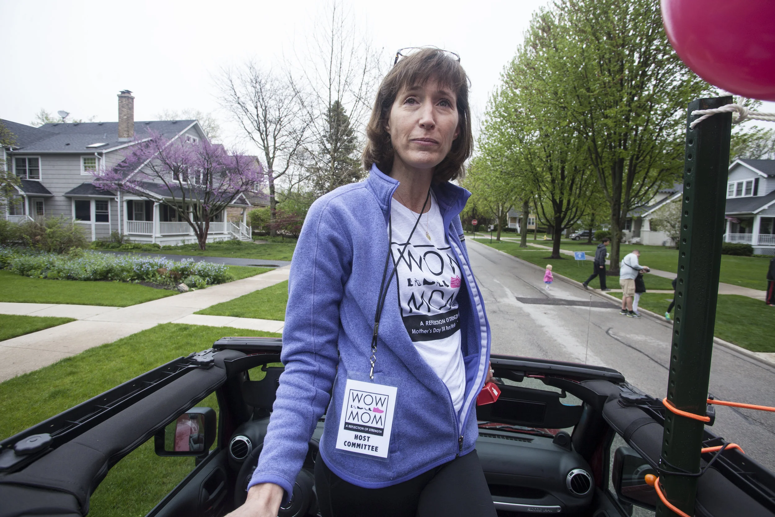 Winnetka resident and Commity Member Janet Beatty watches for runners from her car.jpg