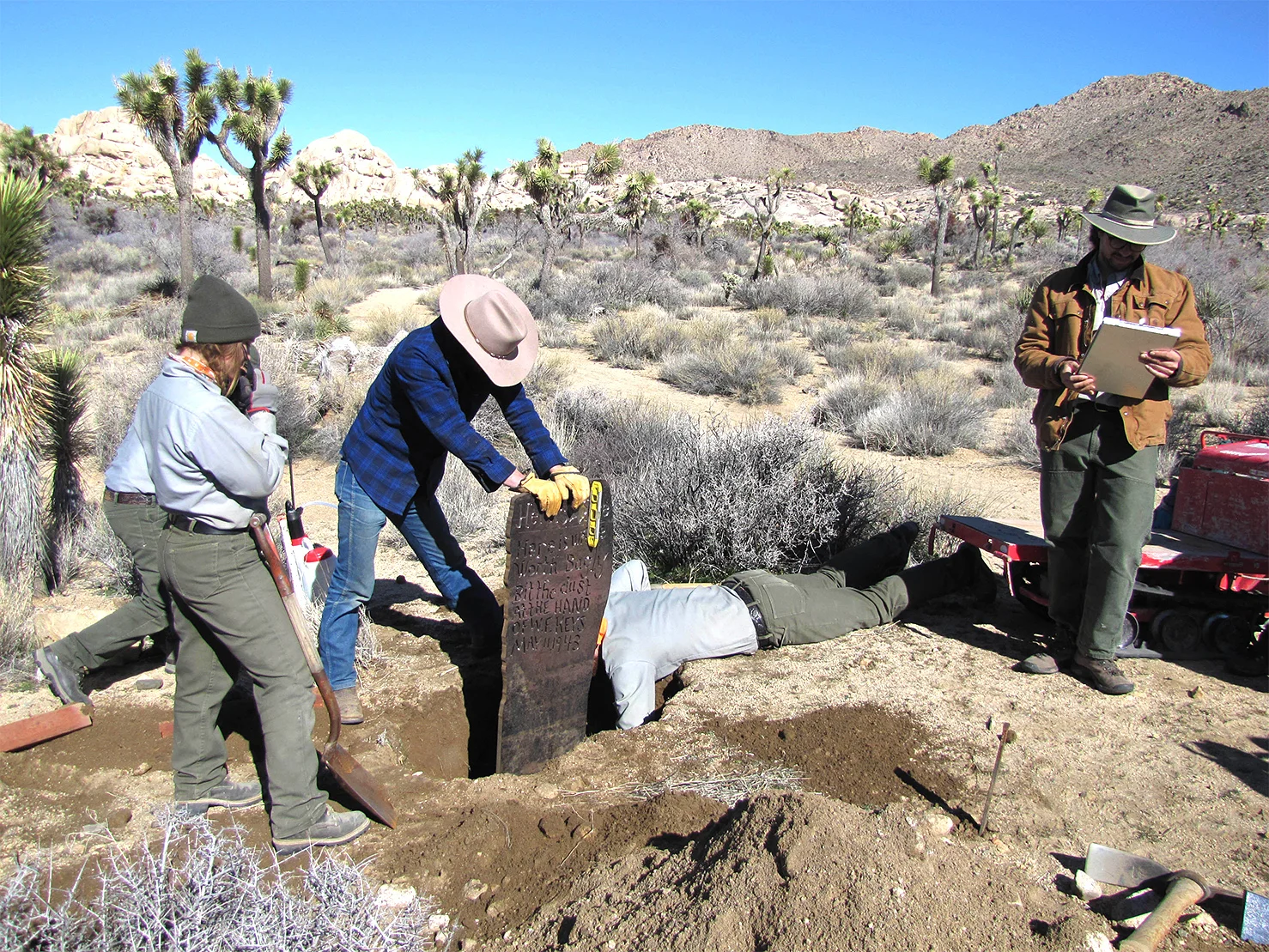 Park personnel placing the replica Bagley marker along the trail to the Wall Street Mill……nps photo