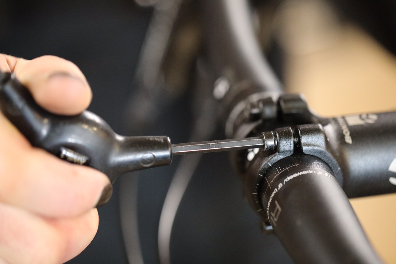Retightening the stem clamp bolts with a Park Tool 3-way hex wrench.