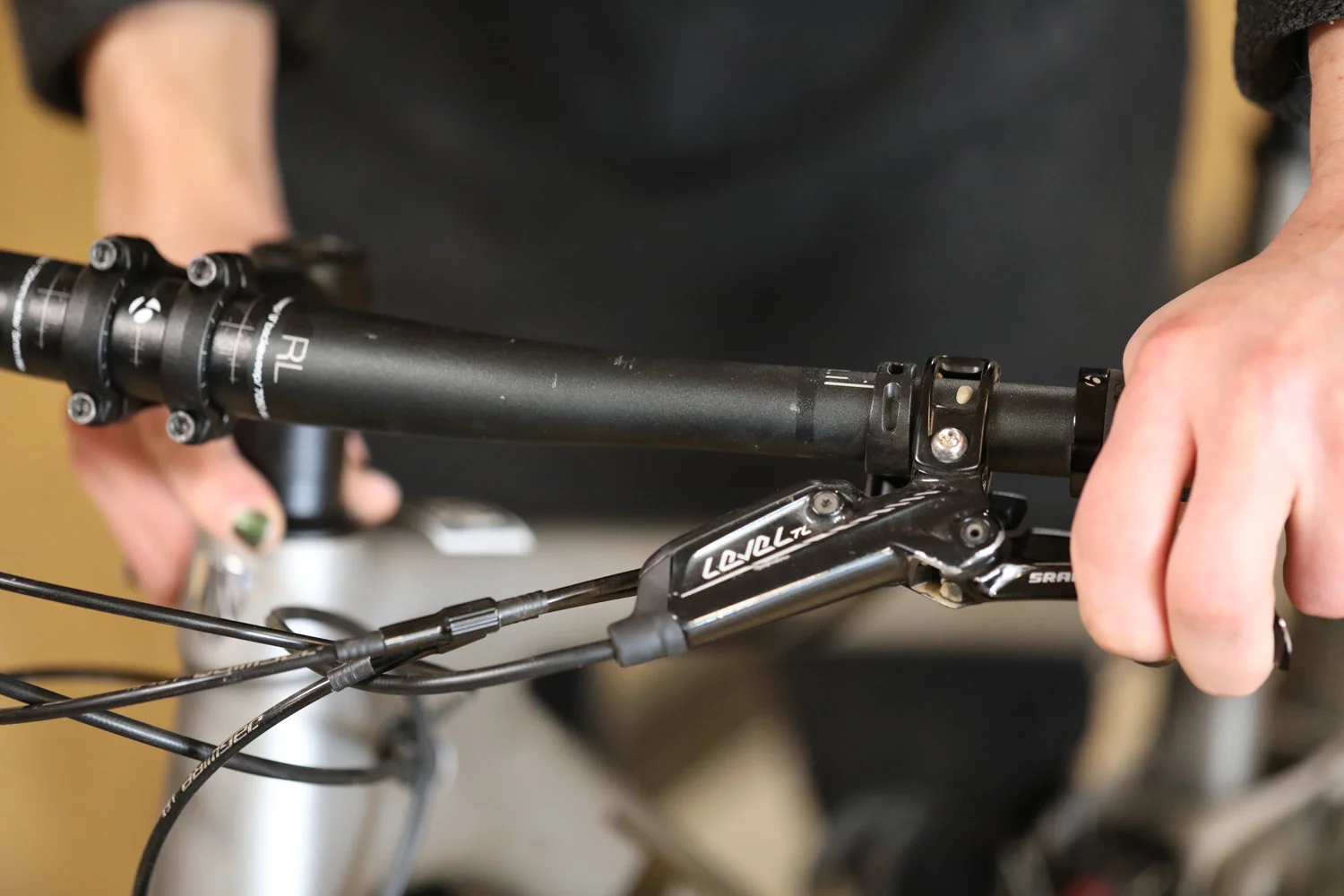 With your left hand holding the front brake as you rock the bike back and forth, you can feel for play between the headset and frame with your right hand.