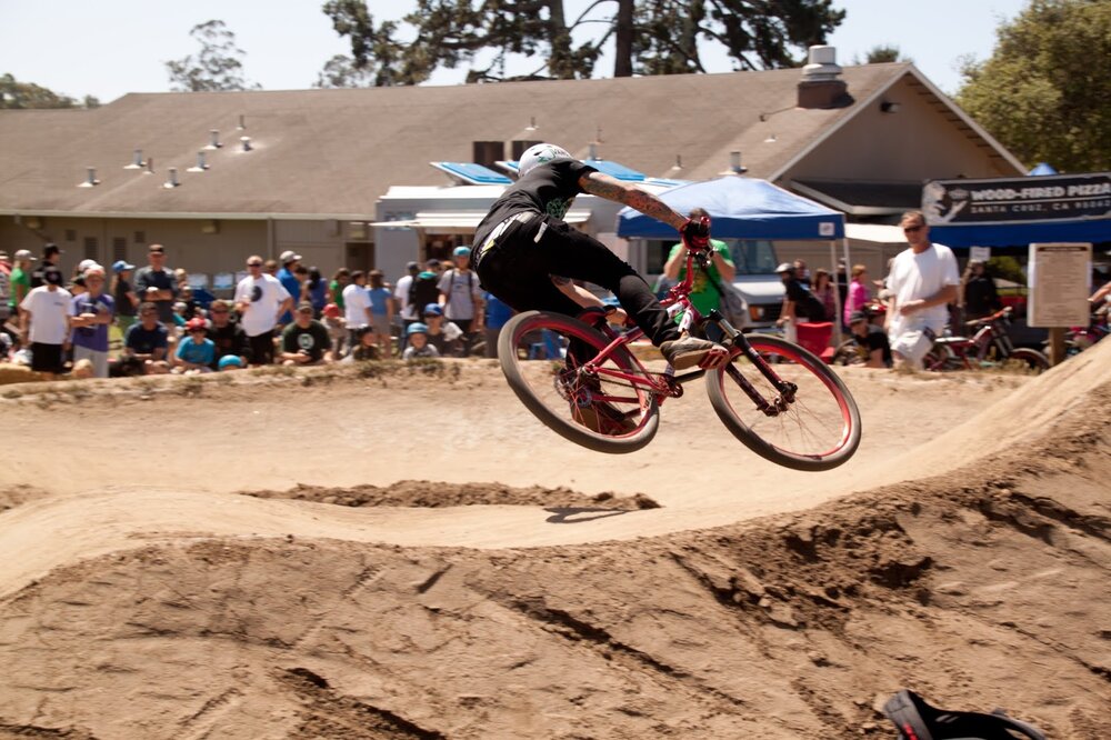 Barry Swenson Builders generously allowed the Epicenter Aptos crew to create a temporary world-class pumptrack (adjacent to the renowned Post Office Jumps) before construction began on the Aptos Village which now occupies that space. Photo: Katie Jo McNair / Santa Cruz Mountain Bike Festival.