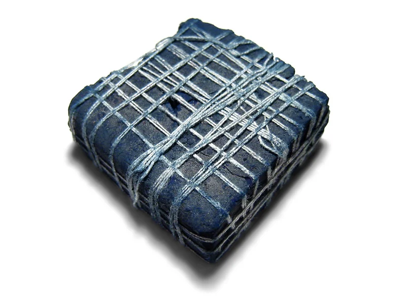 Lump indigo from India - the blue sludge of indigo pigment is dried and sold in blocks