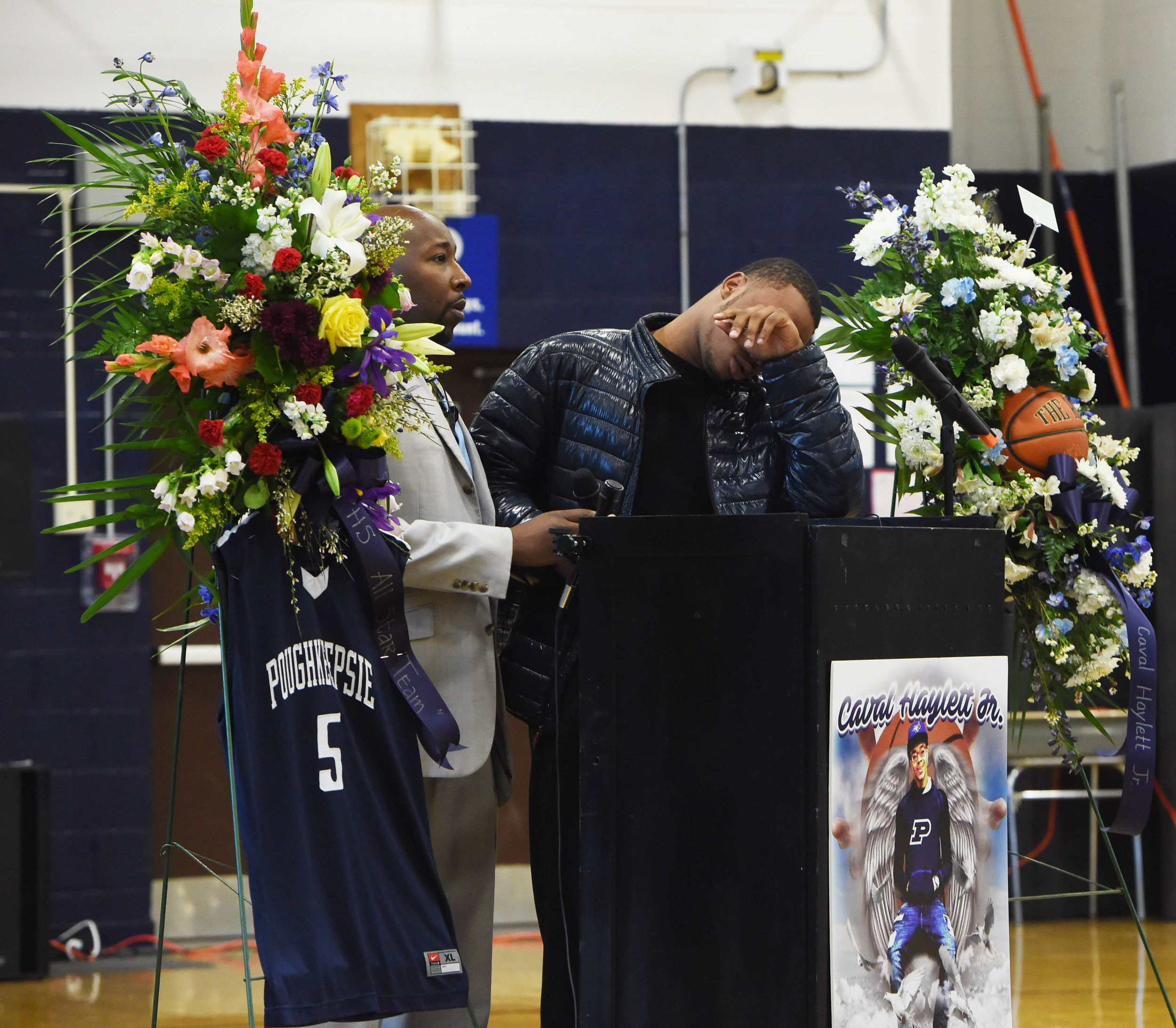  3/14/2016 - Poughkeepsie, NY - Akili Hill, 17, right, a student at Poughkeepsie High School and a member of the school's boys varsity basketball team, is overcome with emotion during the memorial for former teammate Caval Haylett Jr., who was shot o