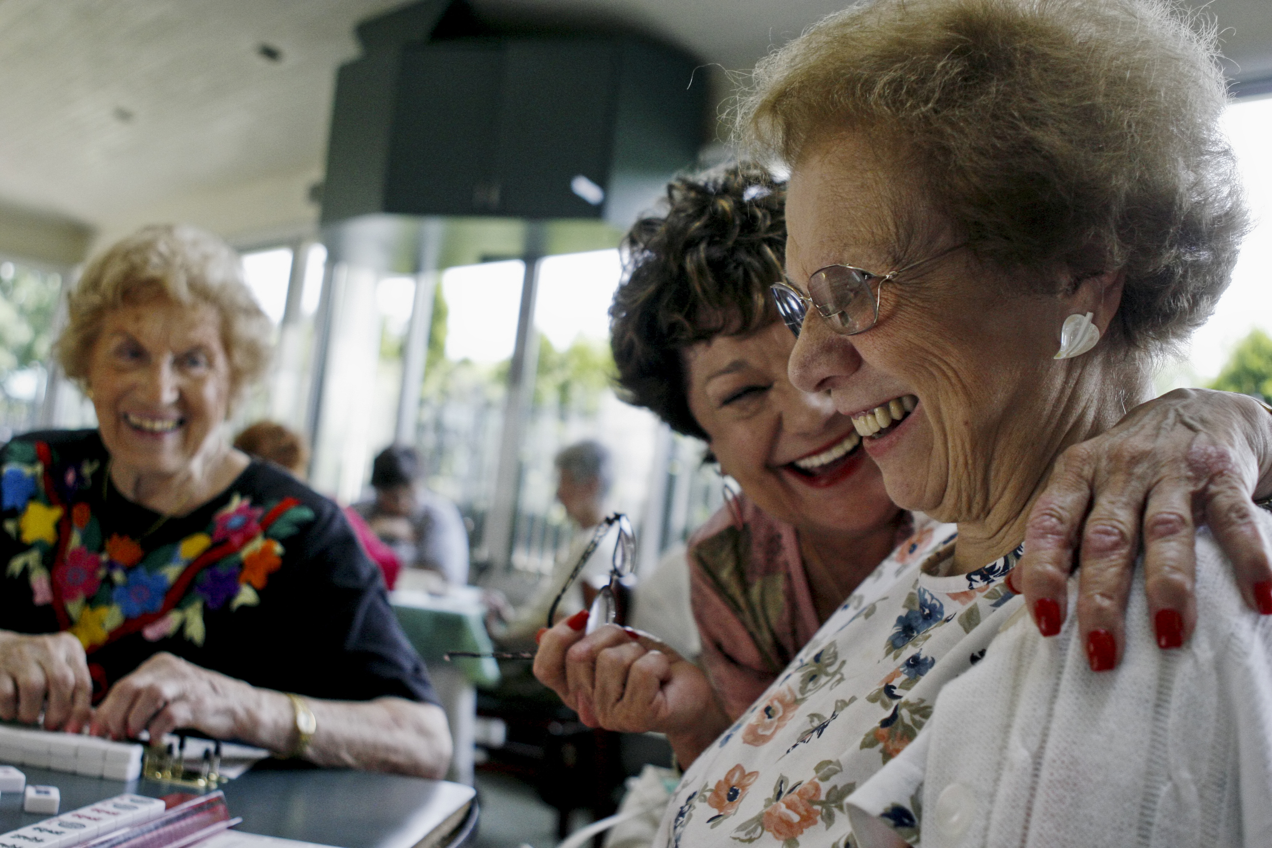  Two older women celebrate a win while playing board games at a local retirement home in Stamford, CT. 