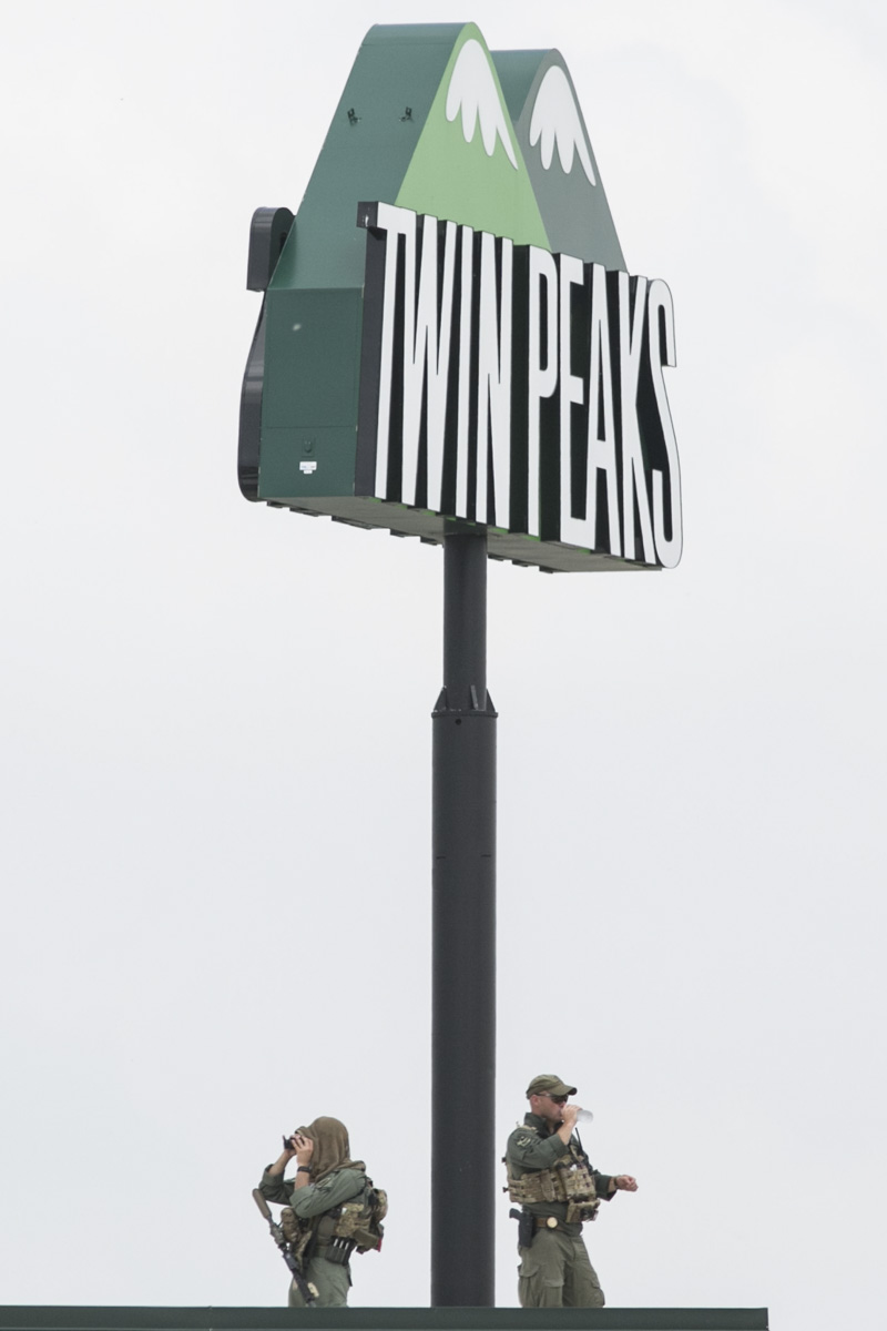  Snipers keep watch from the roof of Twin Peaks restaurant in Waco, Texas, following a motorcycle gang shootout that resulted in the death of nine bikers. 