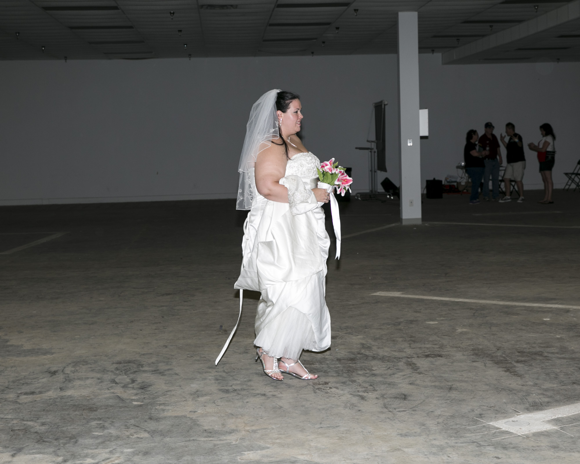  A bride walks across the expo as she prepares to be married during the event. 