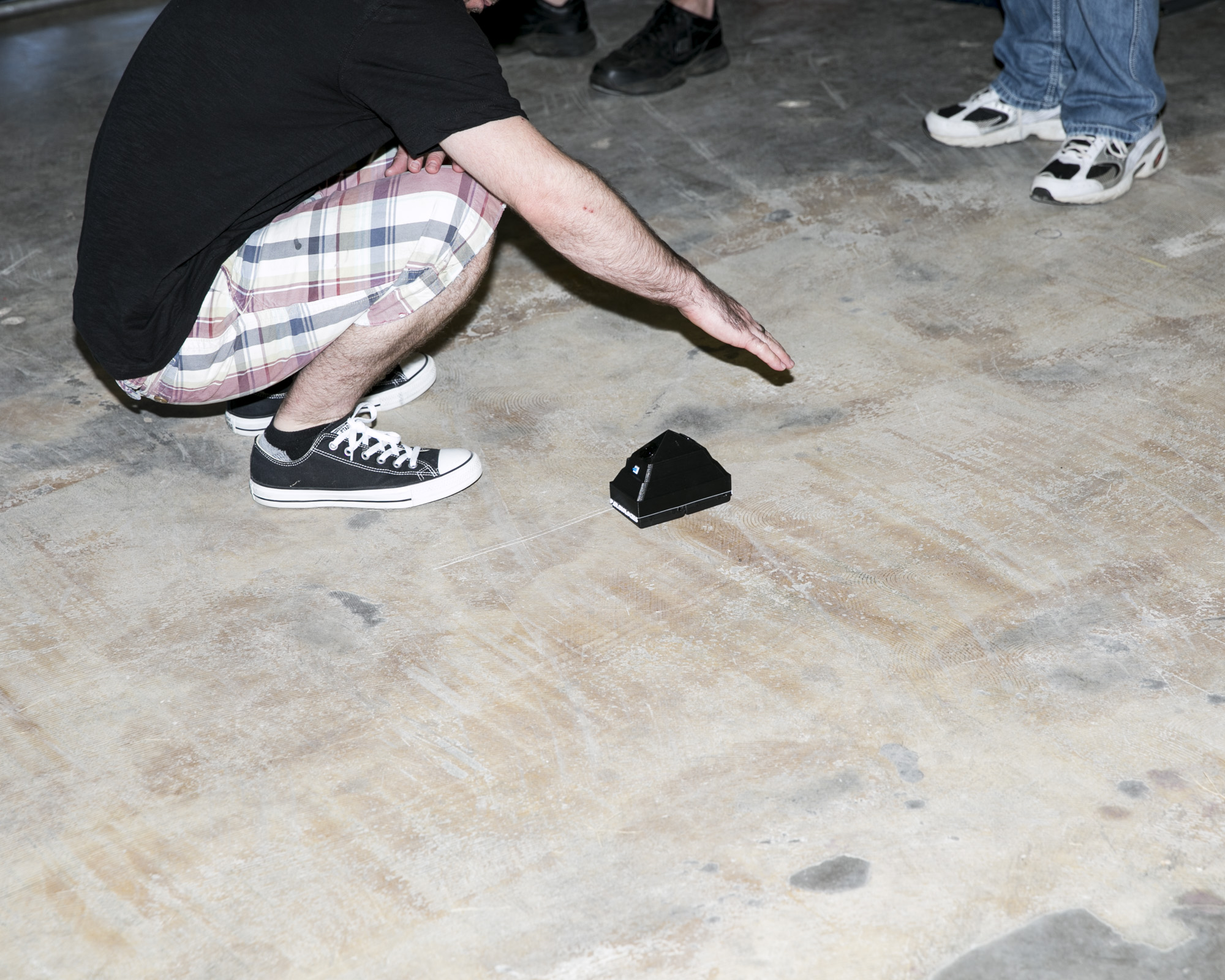  A vendor demonstrates an ultrasonic motion sensor used for detecting paranormal activity. 