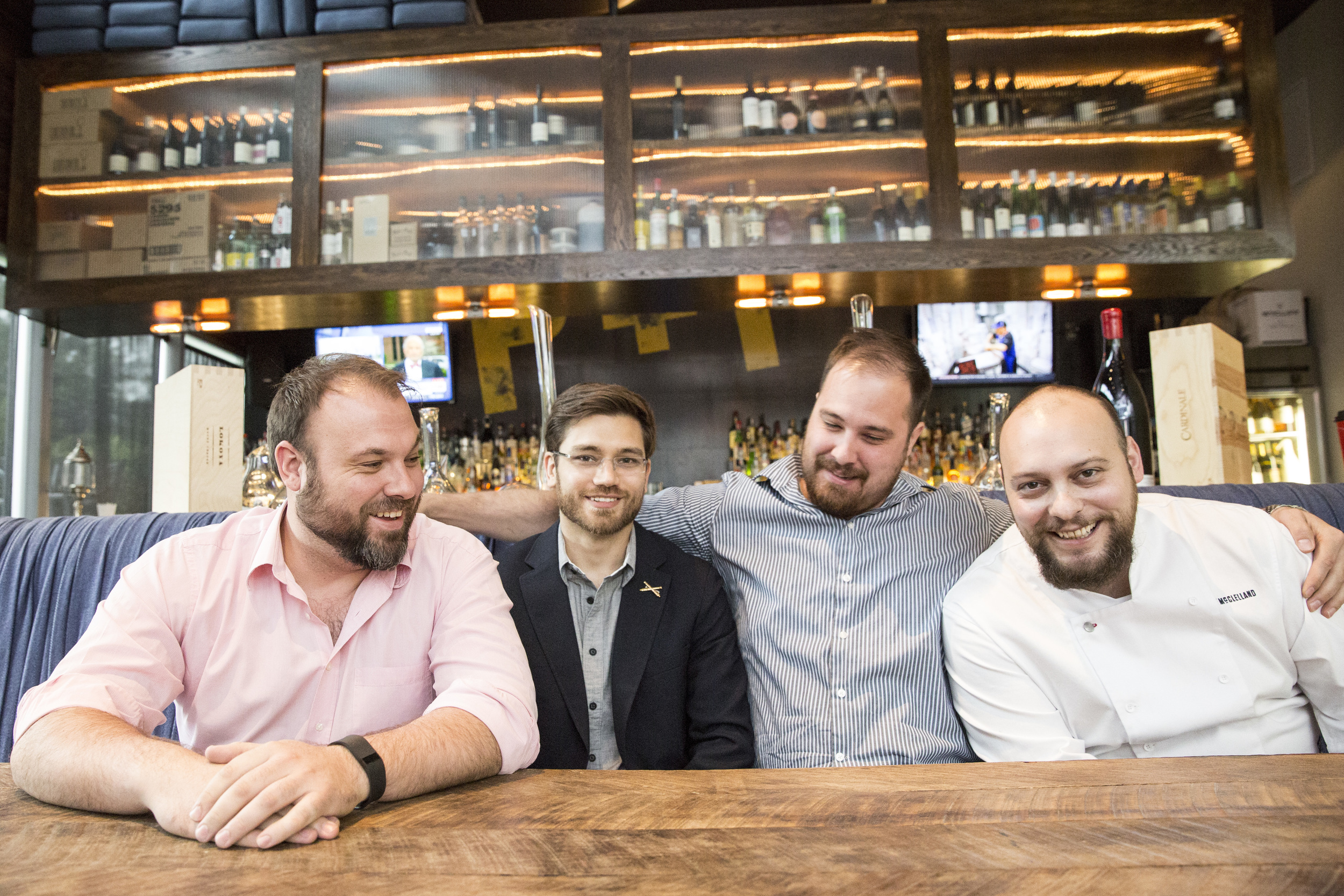  Misery Loves Company partners sit for a portrait in their restaurant, Proof + Pantry. 