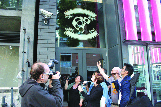 Who's watching whom? Alexander Hayes takes a picture of wearable computer pioneer Steve Mann in Toronto, Canada, during the Veillance.me Conference (IEEE International Symposium on Technology and Society 2013), while Mann uses his EyeTap device and high-definition camera to record a surveillance camera. Is this sousveillance squared? (Photo courtesy of Alexander Hayes.)