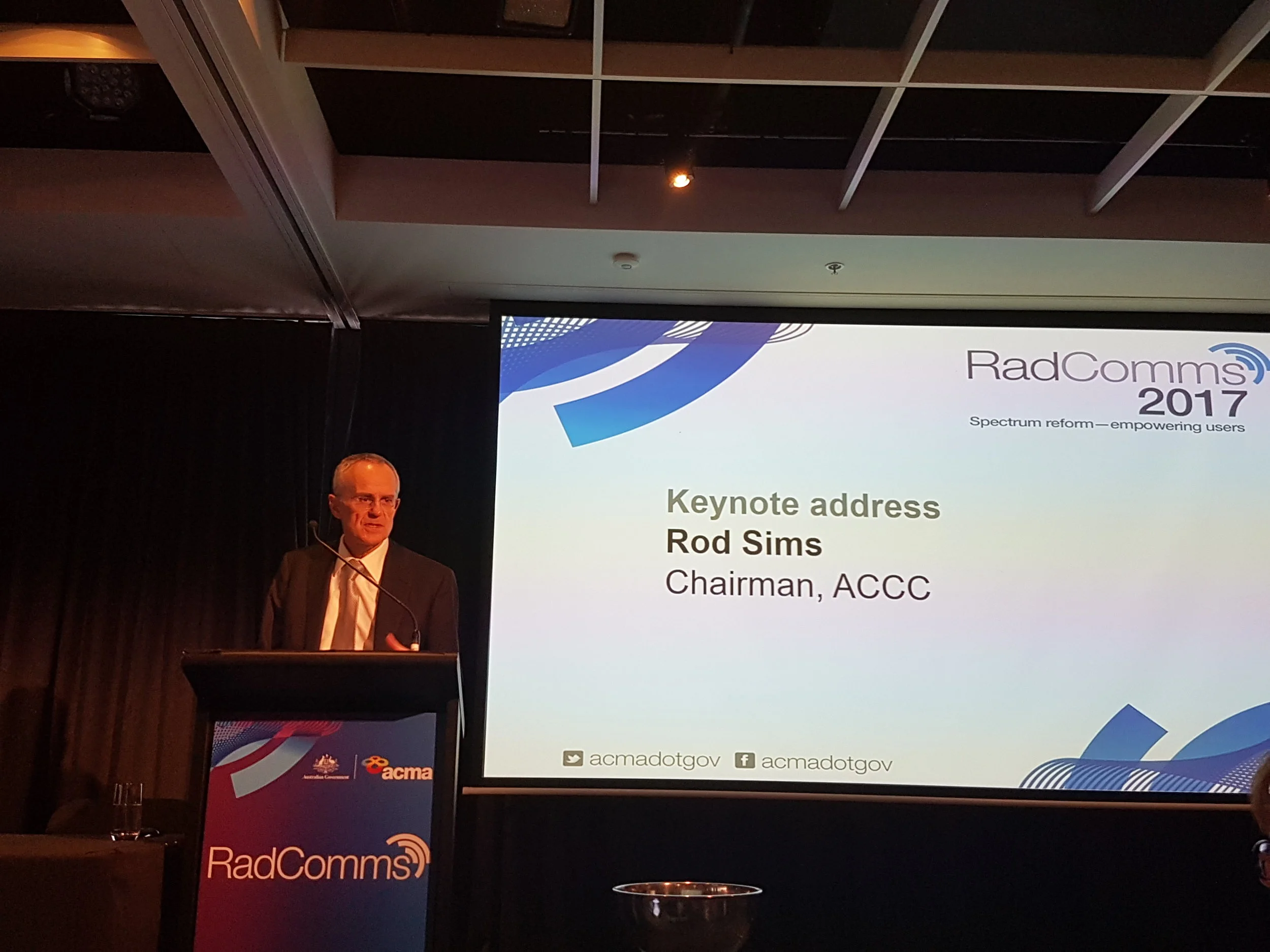 Chairman ACCC, Mr Rod Sims giving keynote address at conclusion of Day 1. "The economic value of the spectrum is the value it will give to the economy, not the one hit/one-off budget boost which is short-term." Here Rod is speaking of the 5G spectrum.