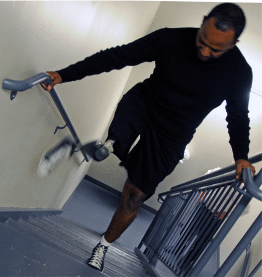Fig. 22. Army Reserve Staff Sgt. Alfredo De Los Santos displays what the X2 microprocessor knee prosthetic can do by walking up a flight of stairs at the Military Advanced Training Center at Walter Reed Army Medical Center (Washington, DC), December 8, 2009. Patients at Walter Reed are testing next-generation prosthetics. Courtesy of the U.S. Army.