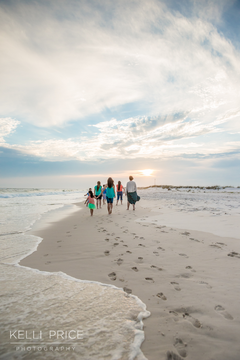 Family walking into the sunset on Destin Beach