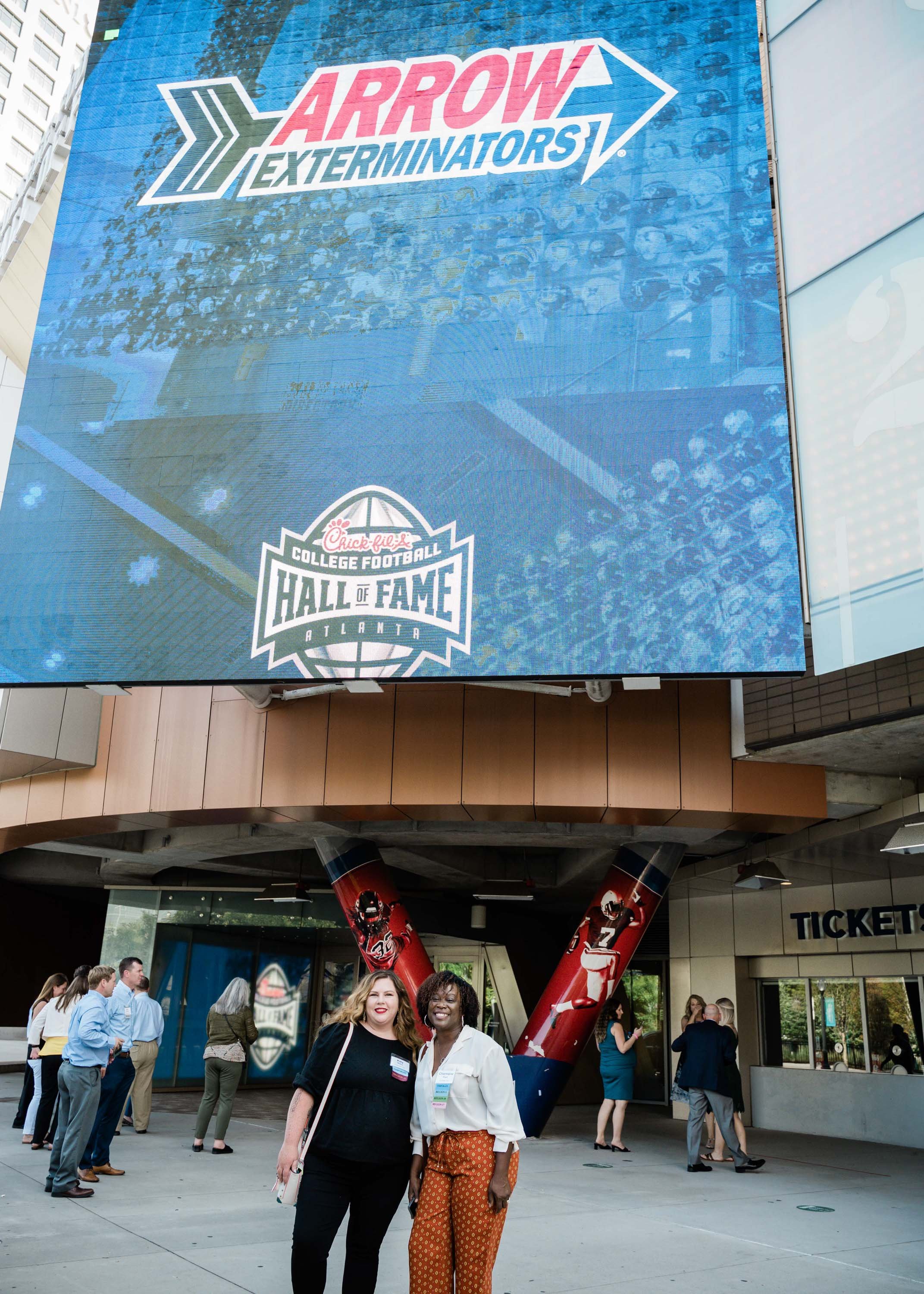  Arrow employees in front of the Chick-fil-a College Football Hall of Fame. 