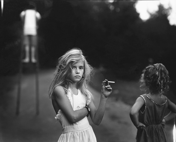 Sally Mann, Candy Cigarette , 1989. Toned gelatin silver print. From the series Immediate Family.
Normal
0
false
false
false
EN-US
X-NONE
X-NONE
/* Style Definitions */
table.MsoNormalTable
{mso-style-name:"Table Normal";
mso-tstyle-rowband-size:0;
mso-tstyle-colband-size:0;
mso-style-noshow:yes;
mso-style-priority:99;
mso-style-parent:"";
mso-padding-alt:0in 5.4pt 0in 5.4pt;
mso-para-margin-top:0in;
mso-para-margin-right:0in;
mso-para-margin-bottom:10.0pt;
mso-para-margin-left:0in;
line-height:115%;
mso-pagination:widow-orphan;
font-size:11.0pt;
font-family:"Calibri","sans-serif";
mso-ascii-font-family:Calibri;
mso-ascii-theme-font:minor-latin;
mso-hansi-font-family:Calibri;
mso-hansi-theme-font:minor-latin;}