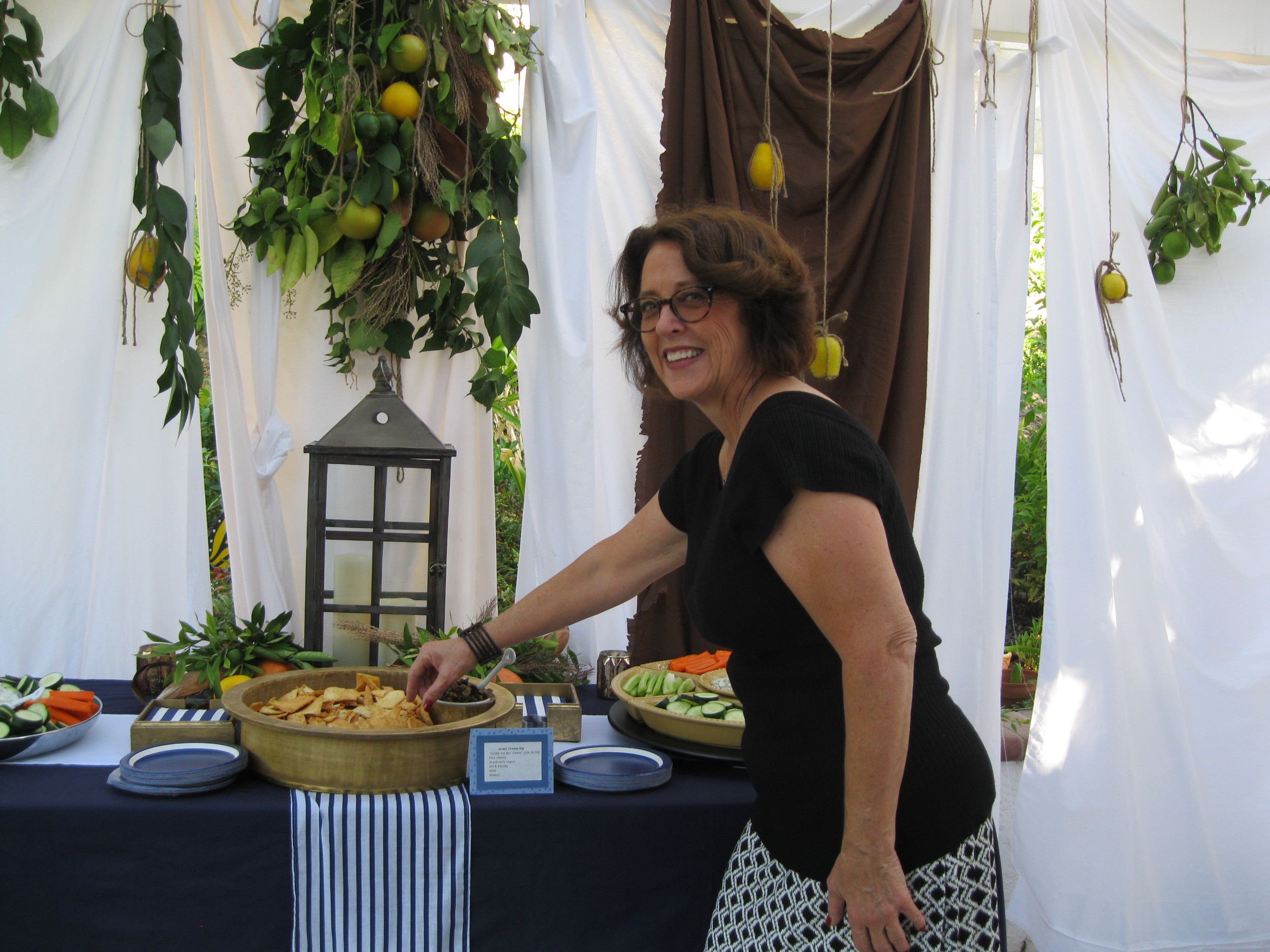 Deby tastes the pita chips and tapenade