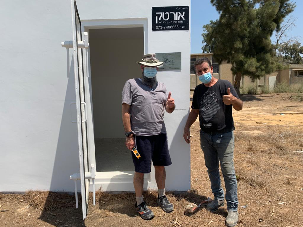  Shmuel Bowman (on the left) finishes placing Song For Israel sign on shelter 