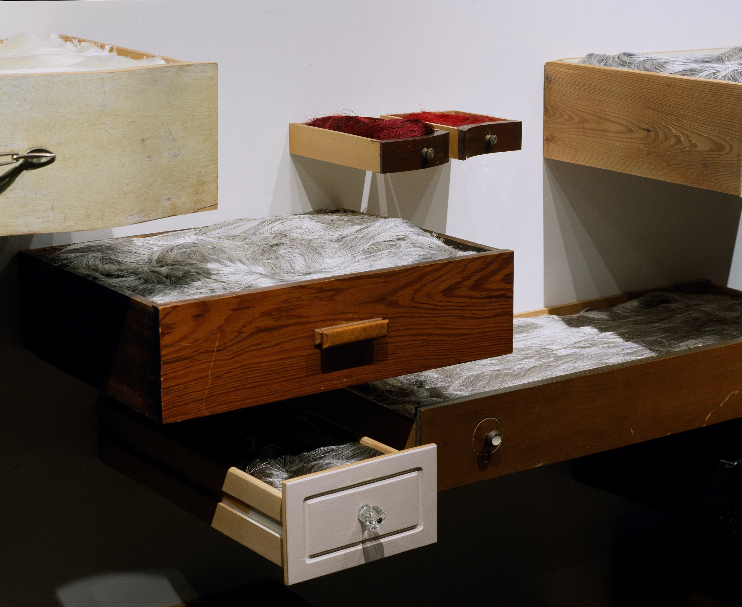 behold detail 2005 found wooden drawers, rayon thread 16 by 7 by 3 feet, variable shown in solo exhibition silences at Belger Art Center, 2005