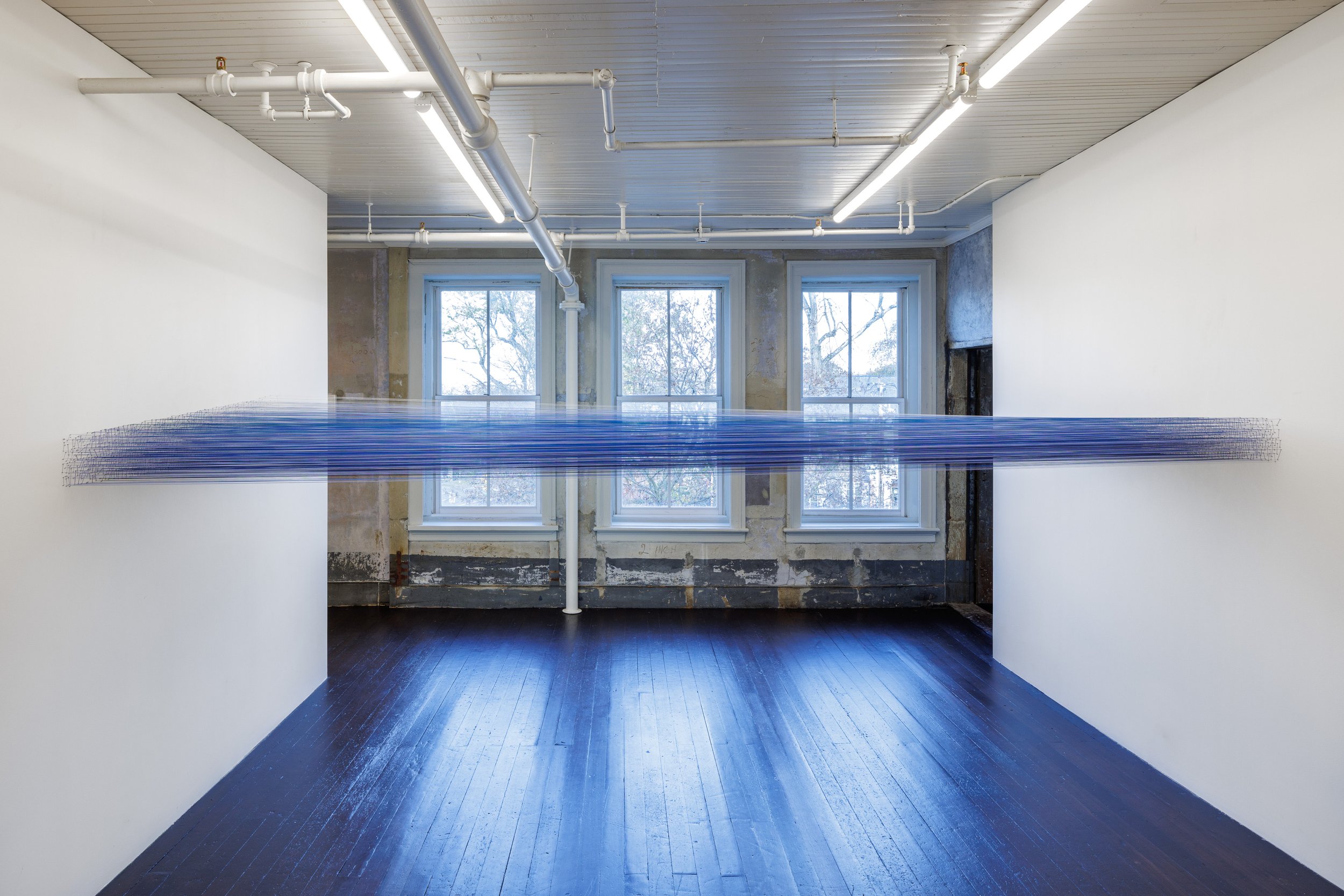    horizon   cotton thread and staples 12 inches x 72 inches x 14 feet  site-specific installation photography by Alon Koppel 