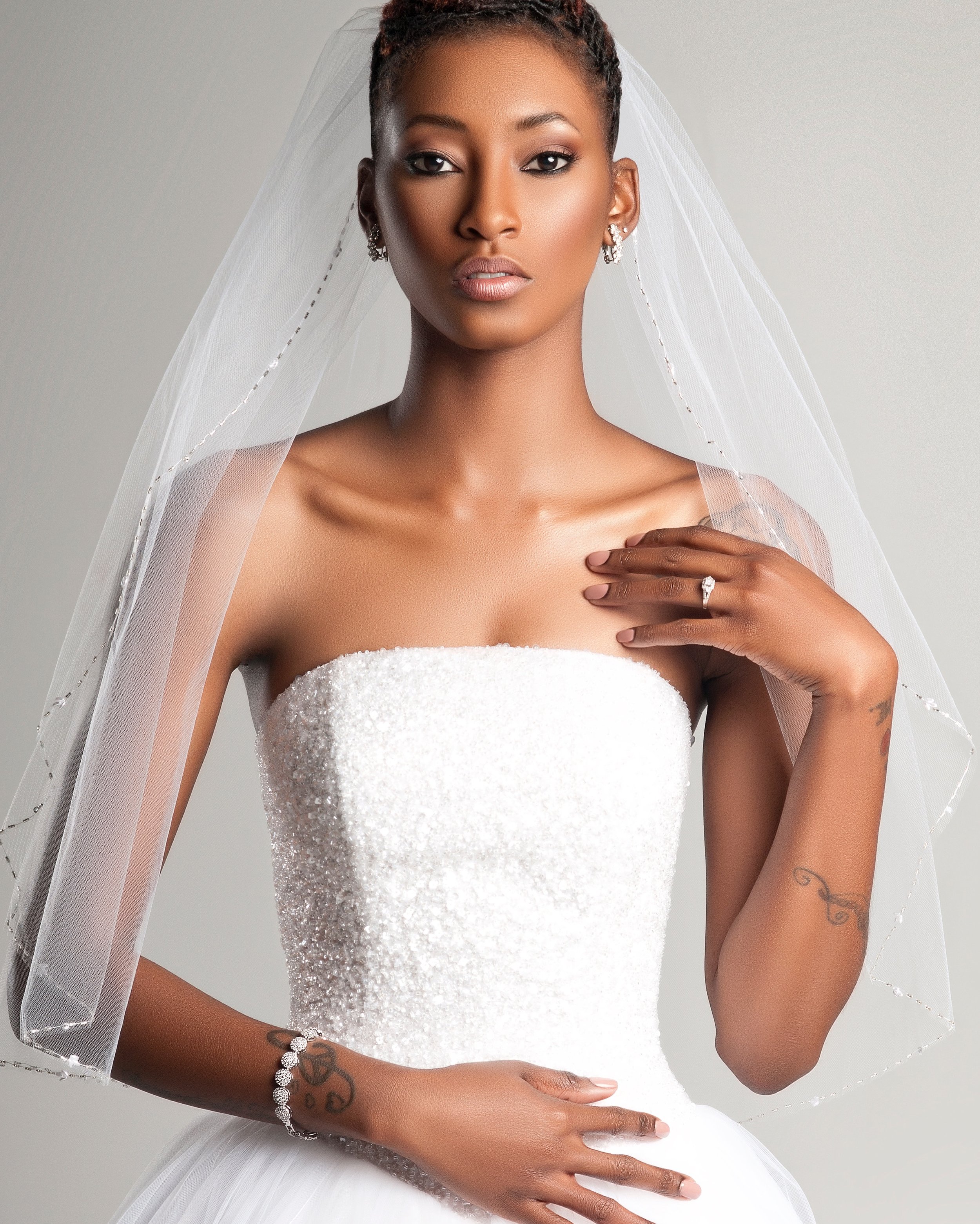 Bride in a strapless lace wedding gown and veil with soft glam bridal makeup