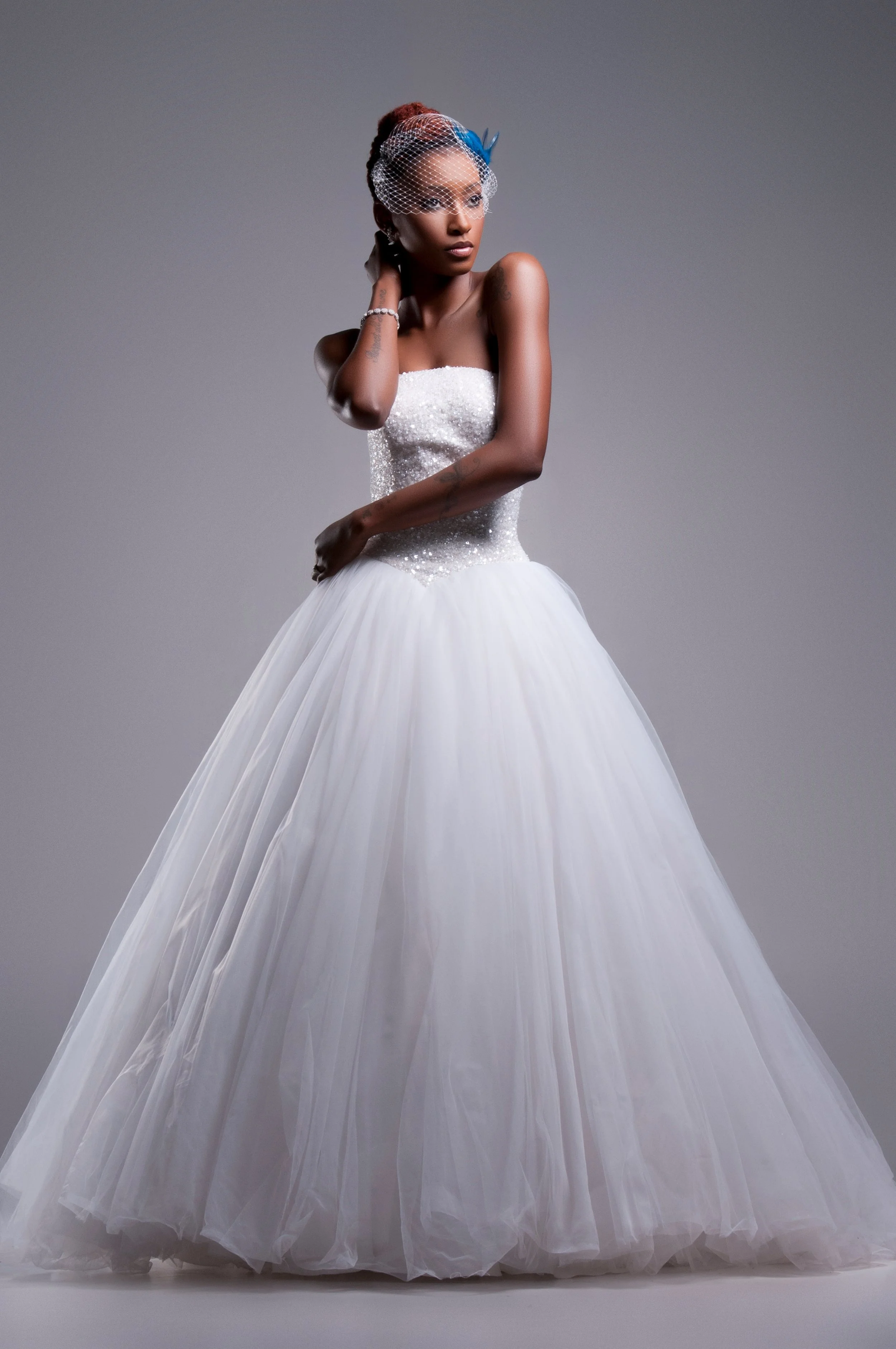 Bride in a strapless ballgown with braided updo, side profile studio portrait