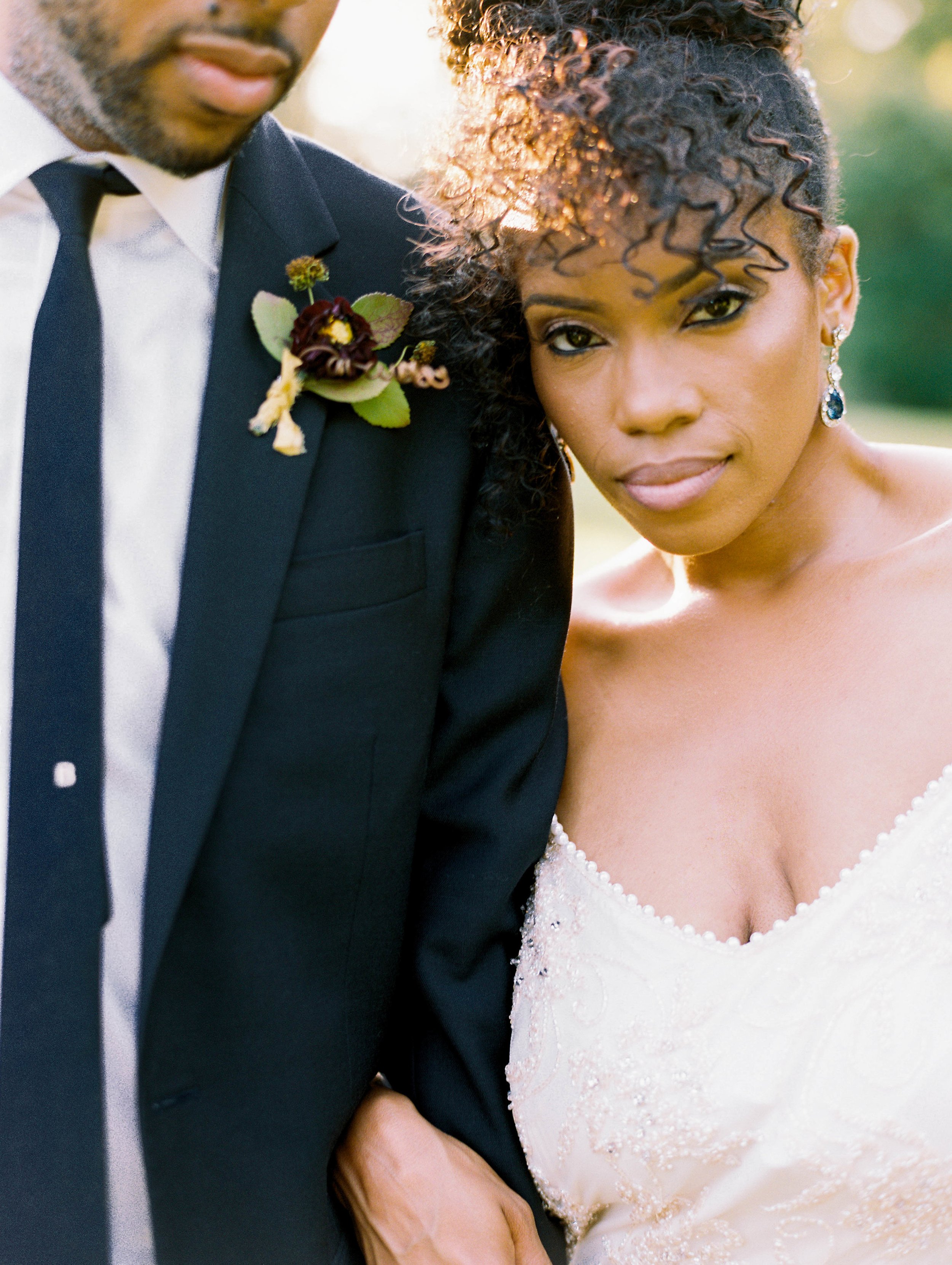 Bride and groom close-up portrait with gold-toned bridal makeup