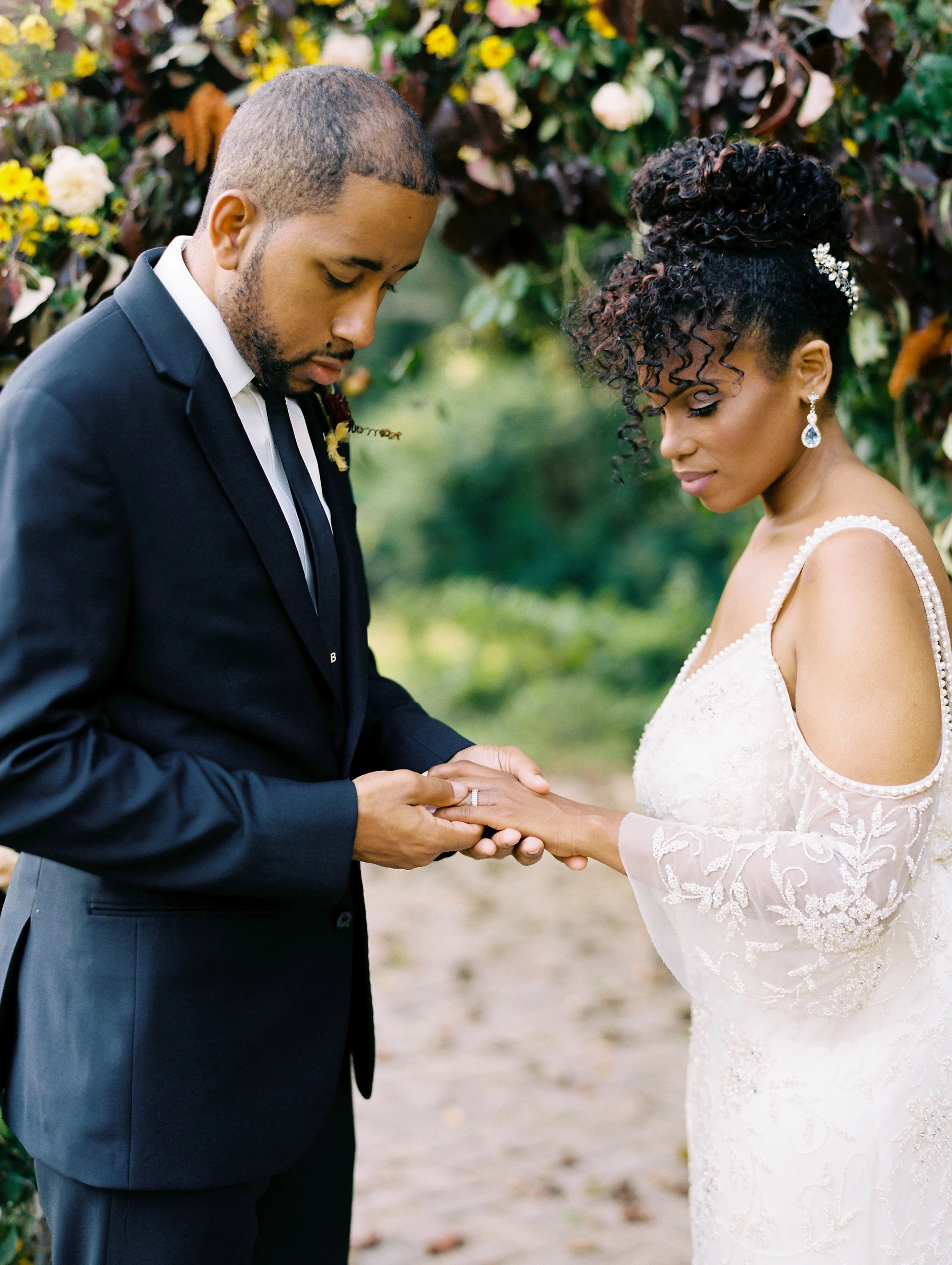 Groom placing the ring on the bride's finger at the ceremony