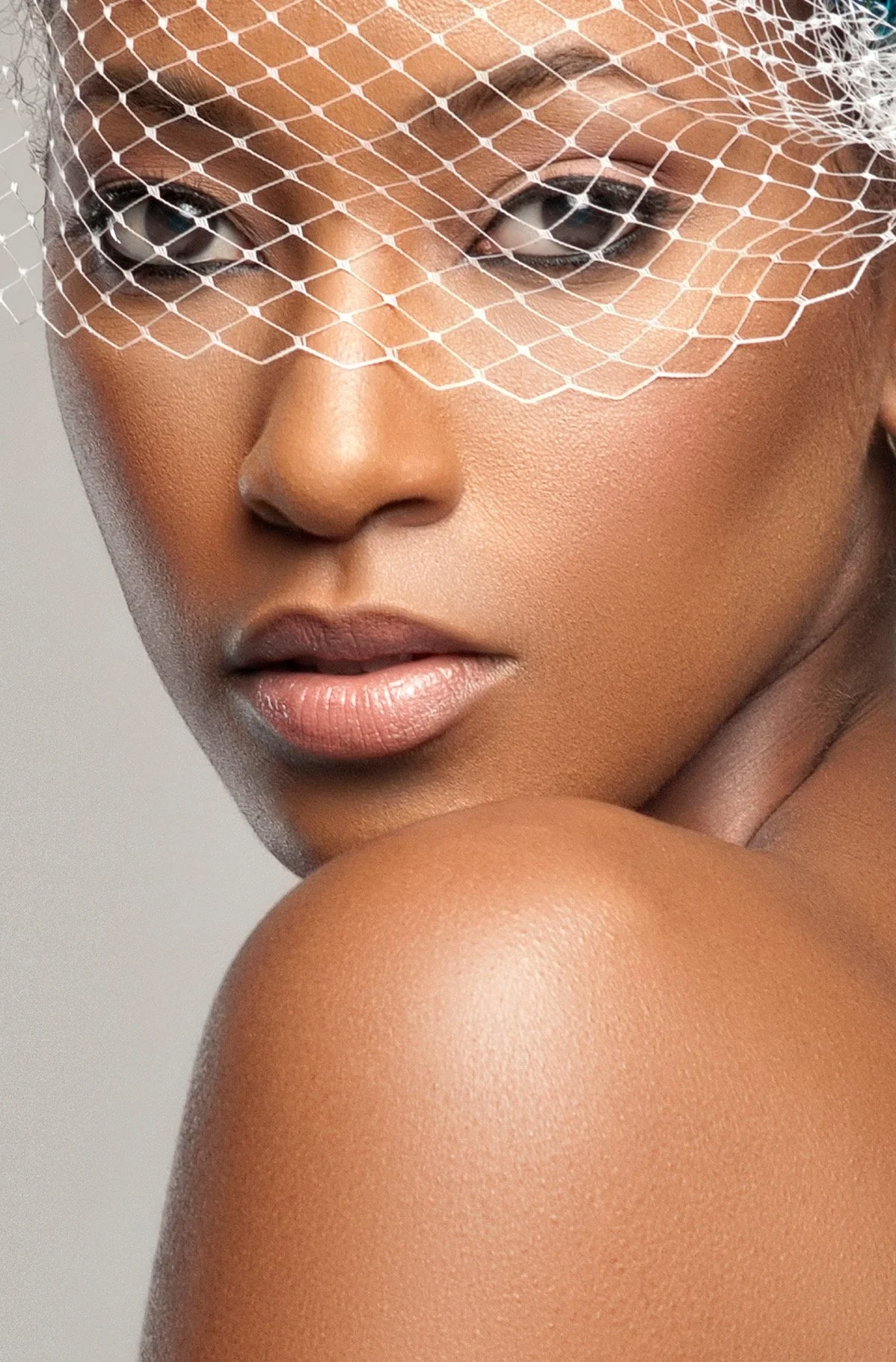 Bride in a birdcage veil with soft glam bridal makeup by Keena Queen