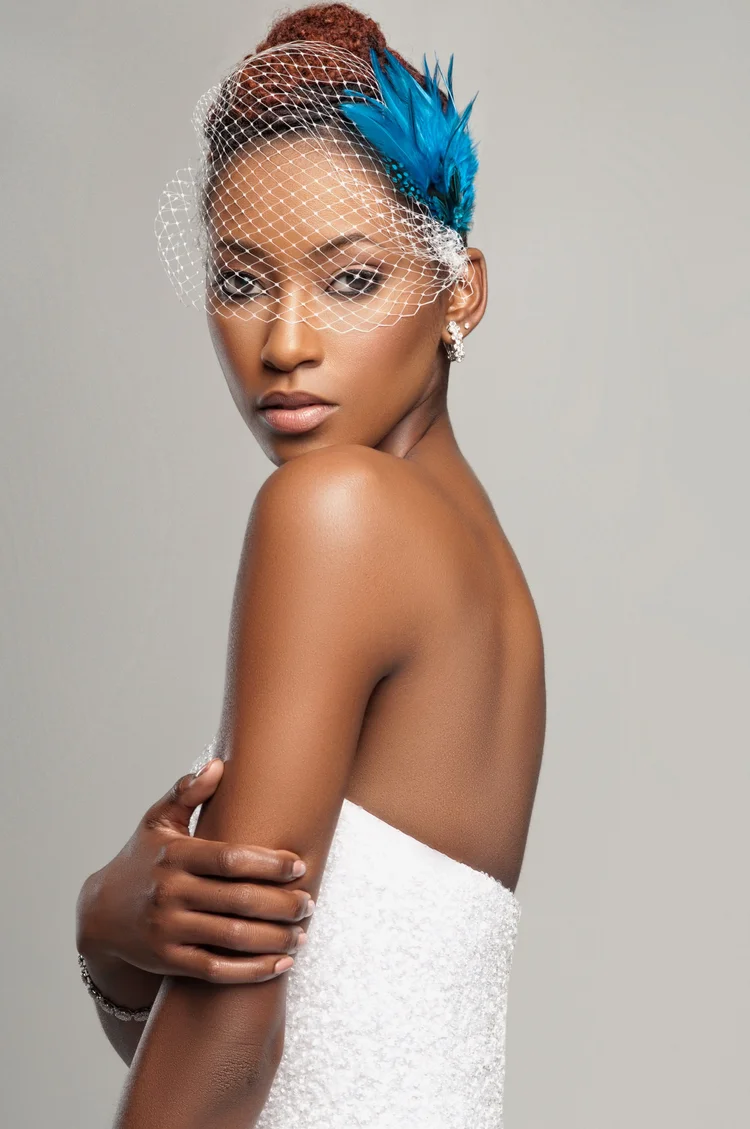 Woman in a birdcage veil with event makeup by Keena Queen