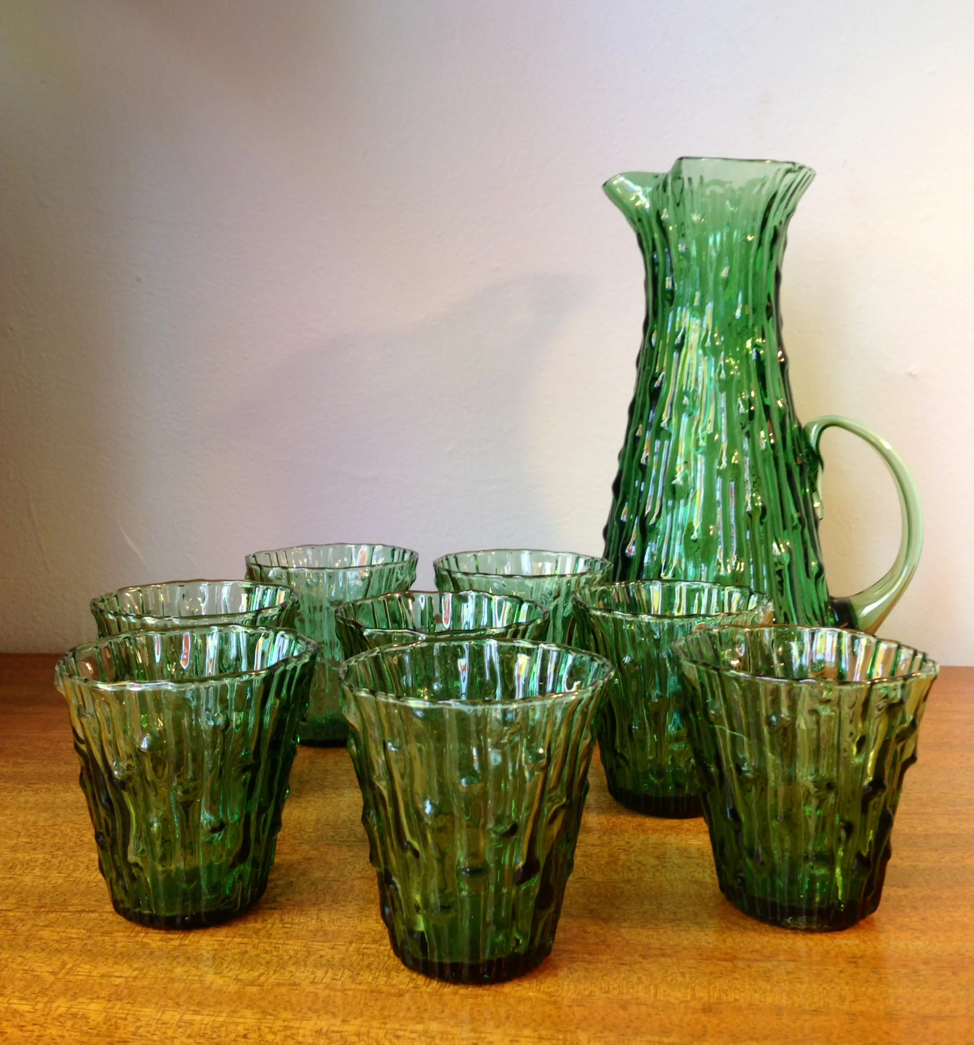 MidModMen believes these are Morgantown "crinkle" glasses and pitcher. Definitely vintage! And we have lots of other juice-sized glasses in stock.. https://www.facebook.com/MidModMen
