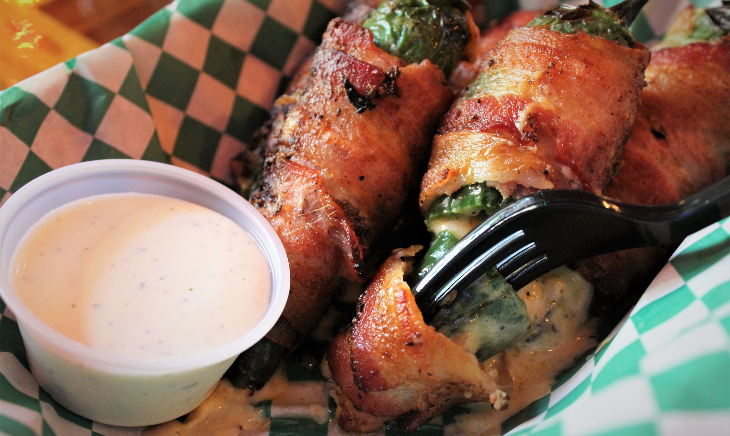 "The Shed's infamous cheese-stuffed jalapenos wrapped in thick-sliced applewood smoked bacon."