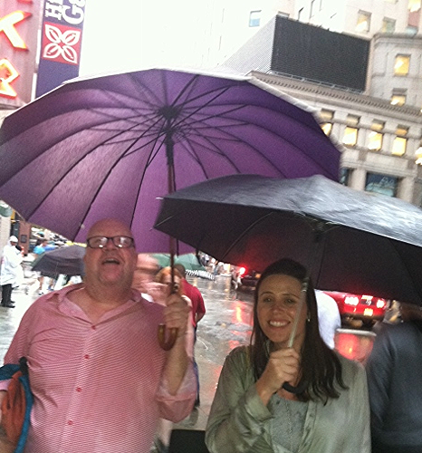 Hunkered under a nut vendor's umbrella during a rain shower, then finally broke down--after we were soaked--and bought umbrellas. 
