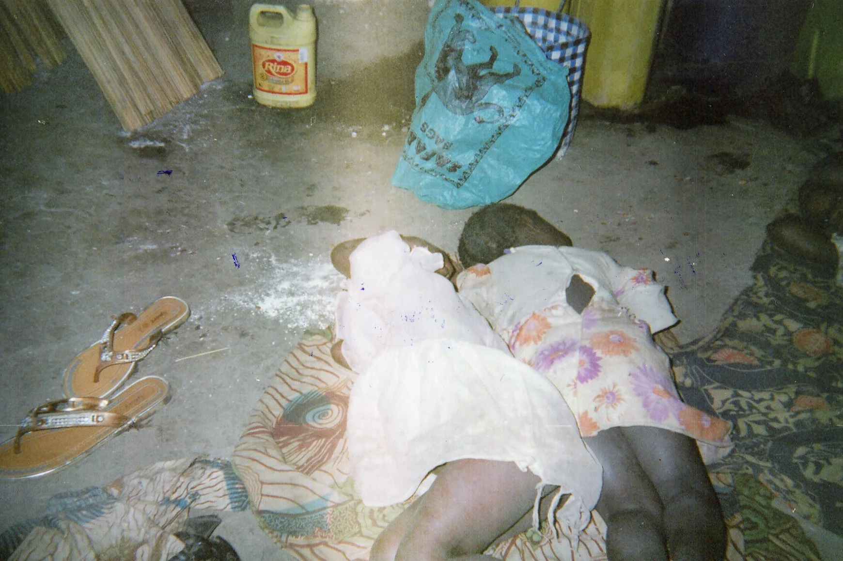 The children sleep, their mom was taken away by force by the militias, leaving her sandals. 