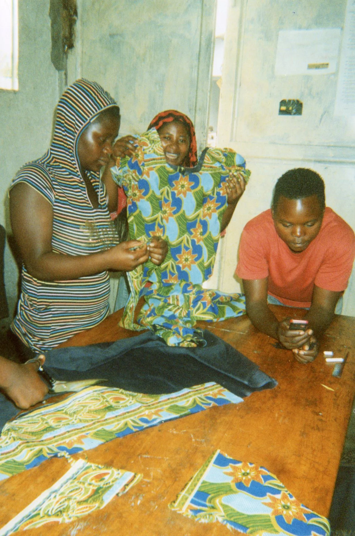 I am showing the teacher the blouse I have been able to make and I am very happy to see how I am able to make a cloth that one can wear. 