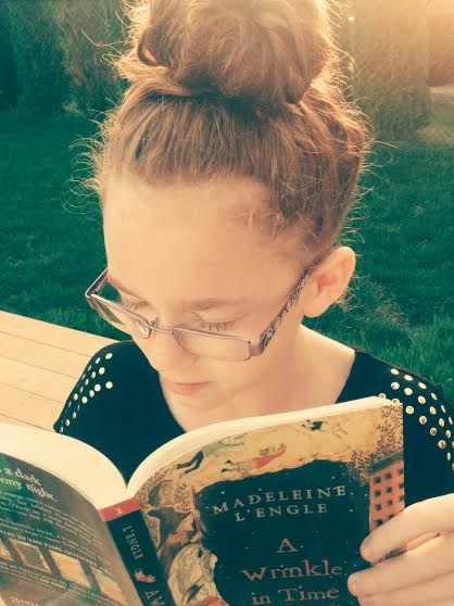Teagan reading A Wrinkle in Time .