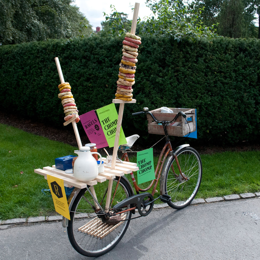 "The Chomp Chomp was a temporary pop-up restaurant and part of the international Restaurant Day in August 2014. We transformed an old bicycle into a colourful bagel cafè, which moved around downtown Oslo. The goal was to introduce an exchange trade, and instead of money we got everything from a hug to a baby sitting deal, and beautiful self-produced vegetables. A nice way to give inspiration for natural ways of colouring food and make people think differently about how they trade in their every day."