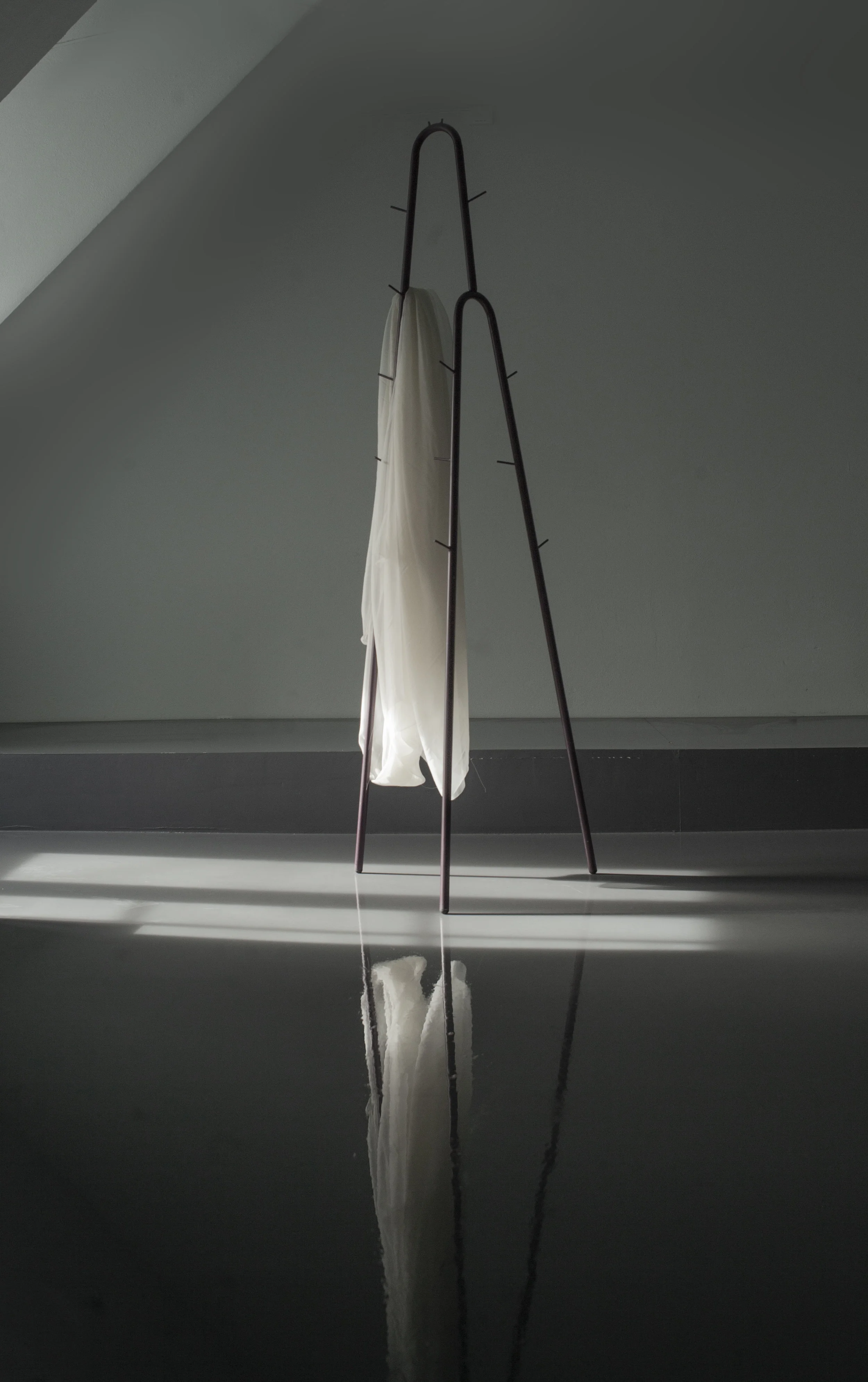 UN #159/256 Cascade coat rack by Edvin Klasson A lightweight and minimalist coat stand compromised of only two parts. Clothes hangers can be hung underneath the tallest loop, and the way each hook is angled makes for generous spacing between each garment.