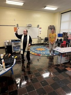 Father Bob blessing Mrs. Johnson's classroom